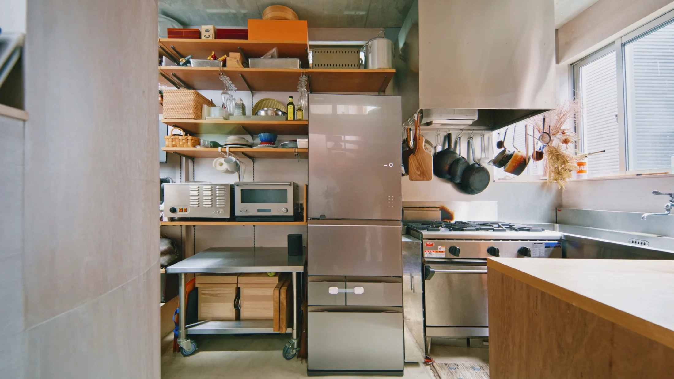 (BELOW) Belongings, kitchenware and life's essentials don't need to be hidden away to make for a tidy and attractive kitchen. Flagpole House in Nakameguro, designed by Motoki Yasuhara of SALHAUS, once again utilises a mixture of baskets and boxes, along with an abundance of hooks and strategically spaced shelving. Image: Never Too Small.