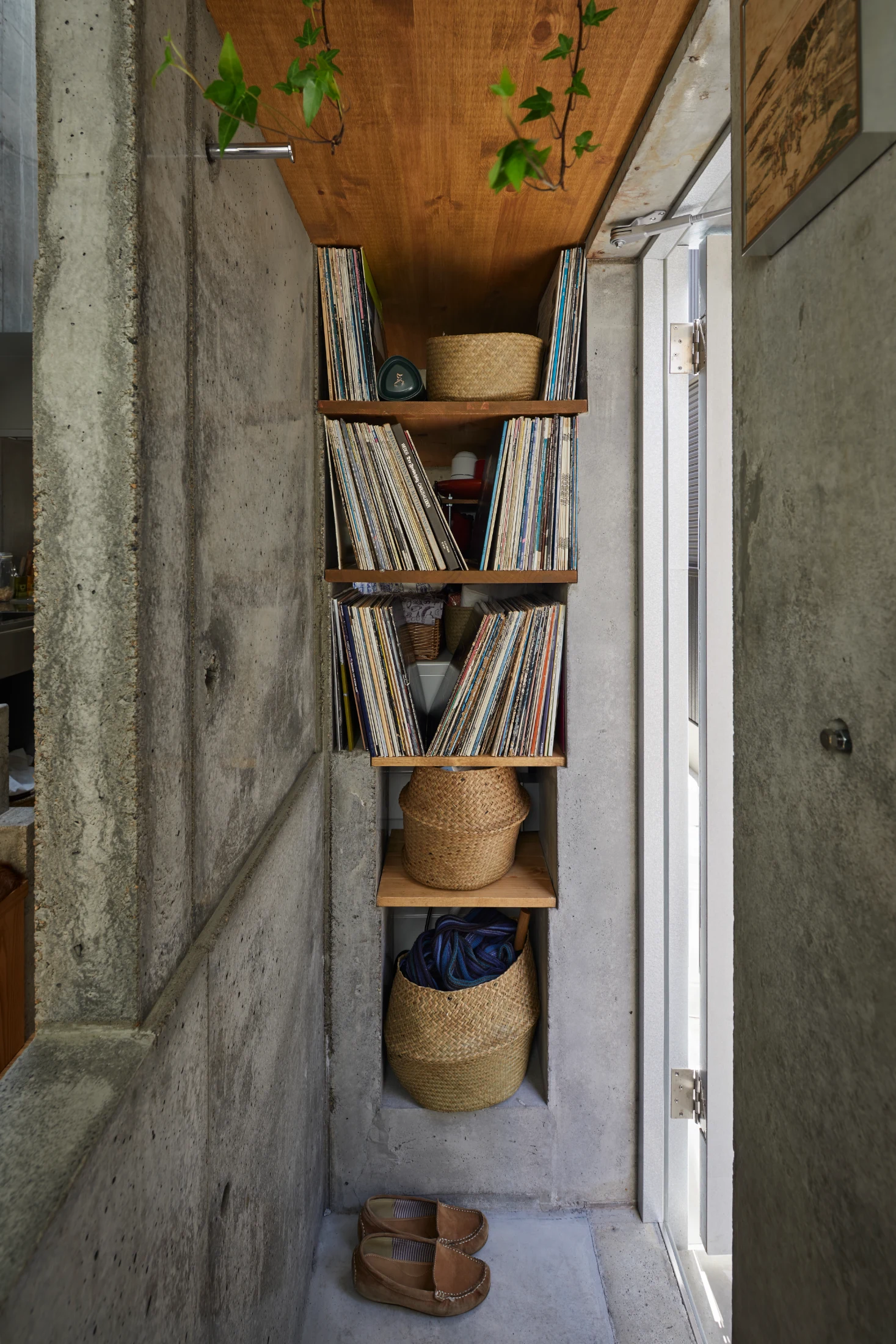 In Takeshi and Megumi Hosaka's home in Tokyo (Love House 2 designed by Takeshi, see p24), infrequently used items are tucked in the back of a deep set of shelves with more everyday items and Takeshi's beloved record collection front and centre. Takeshi specifically designed these shelves to store his record collection and Takeshi's beloved records are satisfyingly supported by gentle edges that were precast into the concrete. Note: the shelves have no brackets or pins but are supported by gentle edges. Image: Nacasa & Partners Inc.