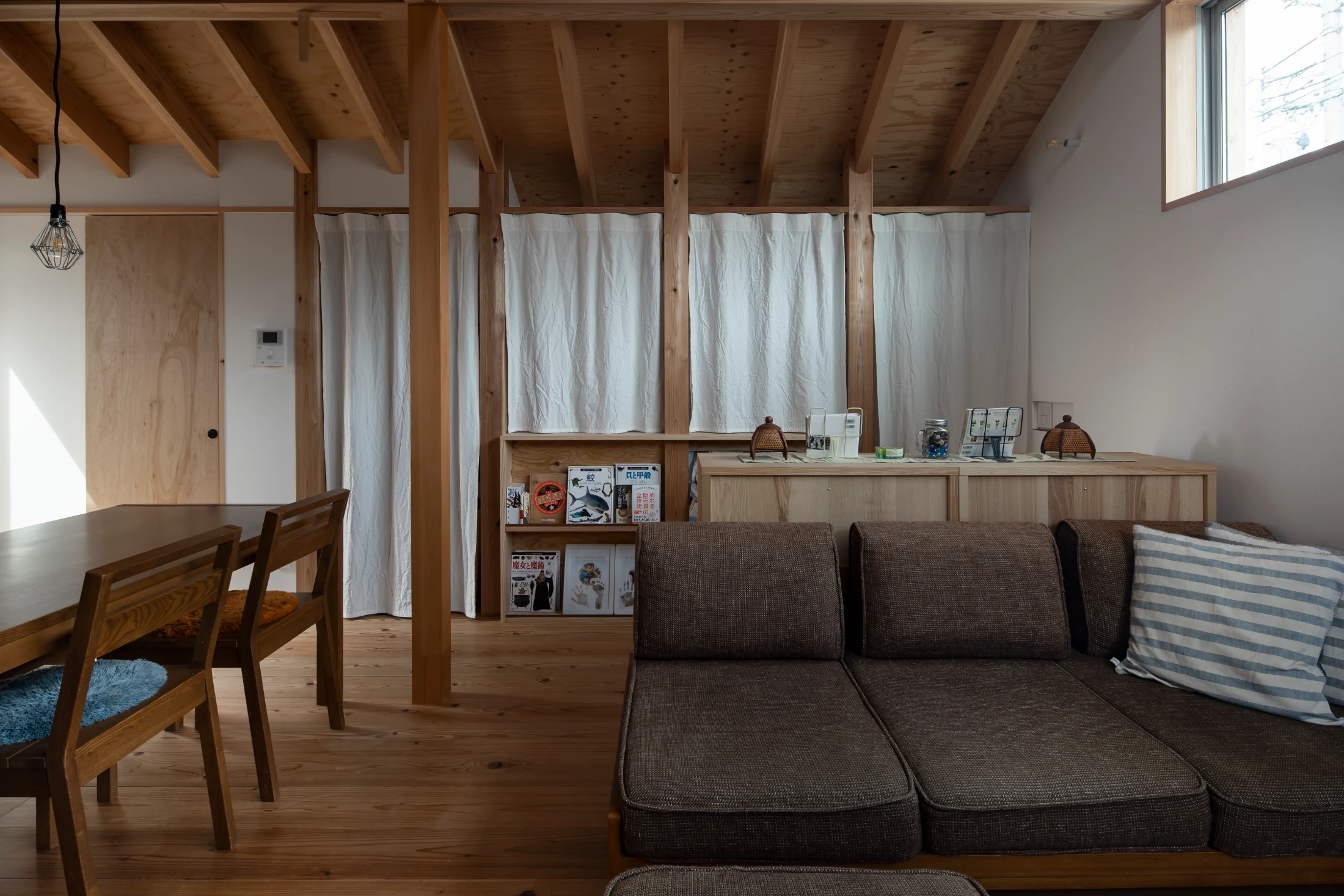The neutral and natural material palette of f-house in Osaka, designed by Kazuteru Matumura of Coil, was designed to accommodate the family's existing furniture and emphasise the enjoyment of gentle suggestions of colour. Soft furnishings offer gentle suggestions of colour. Image: Keishiro Yamada.