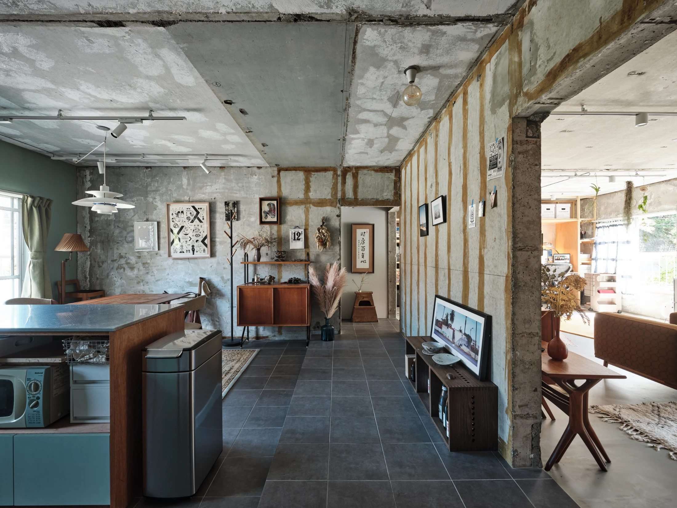 (BELOW) While concrete can often be thought of as a 'cold' material, in the home Takeshi Hosaka designed for he and his wife, Megumi, it is anything but cold. Light illuminates its bumps and joins, and it acts as the canvas for the things that bring the couple joy. Image: Nacasa & Partners Inc.
