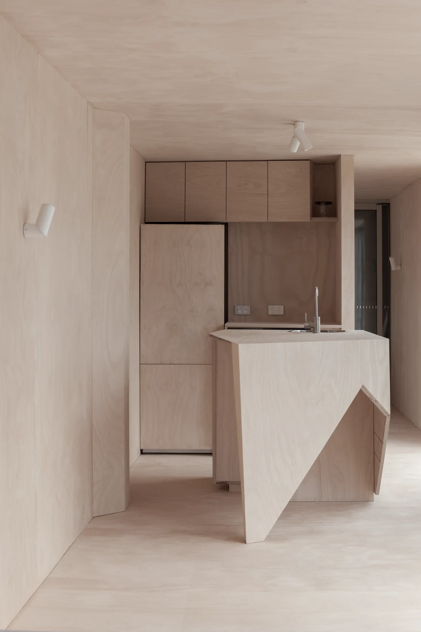 Interior spaces lined with marine plywood define House 28: a 50-square-metre weekend retreat in Wye River, Australia, made from shipping containers. Image: Tony Gorsevski.