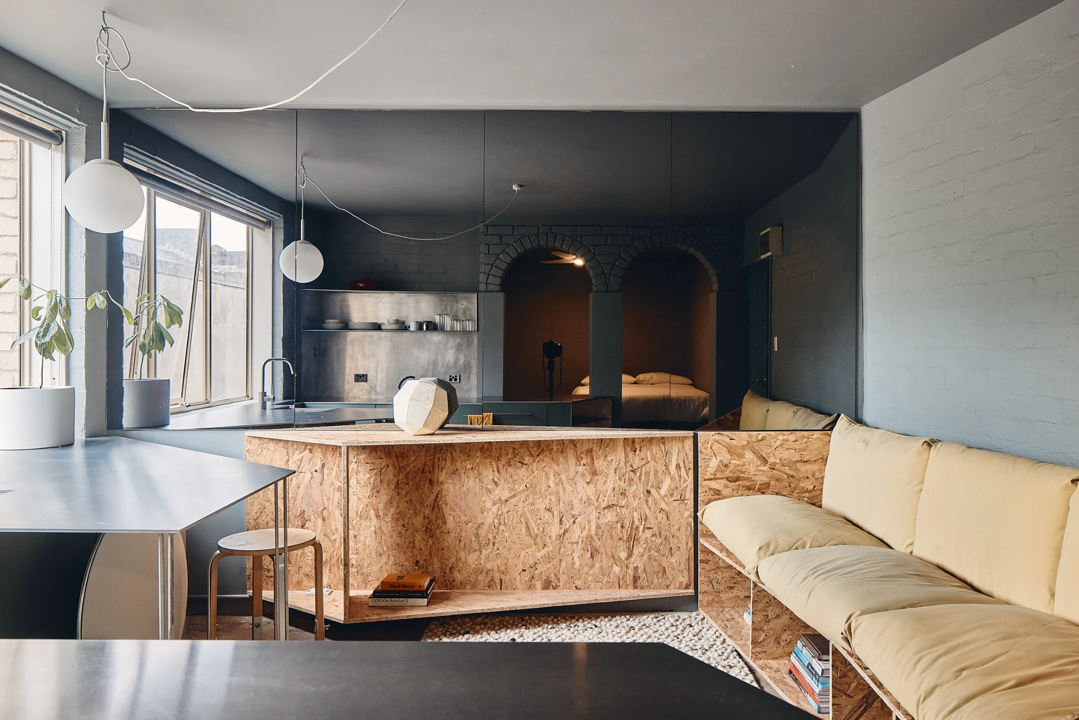 Sharp angles, oriented strand board (OSB) and raw aluminum feature in Studio Edwards' design of Microloft, a 24-square-metre apartment in a 1980s block in Melbourne's Fitzroy. Image: Peter Bennetts.