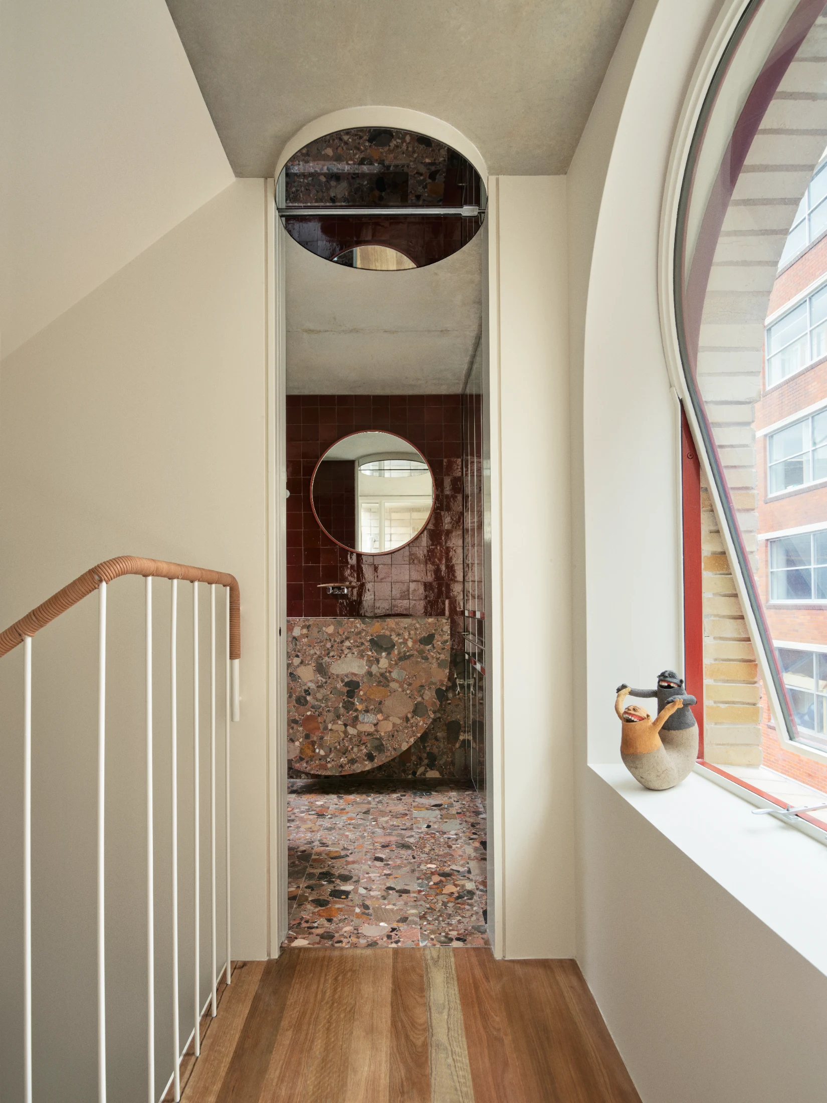 A circular mirror detail in the ceiling of the ensuite cleverly conceals a surface-mounted sliding track (