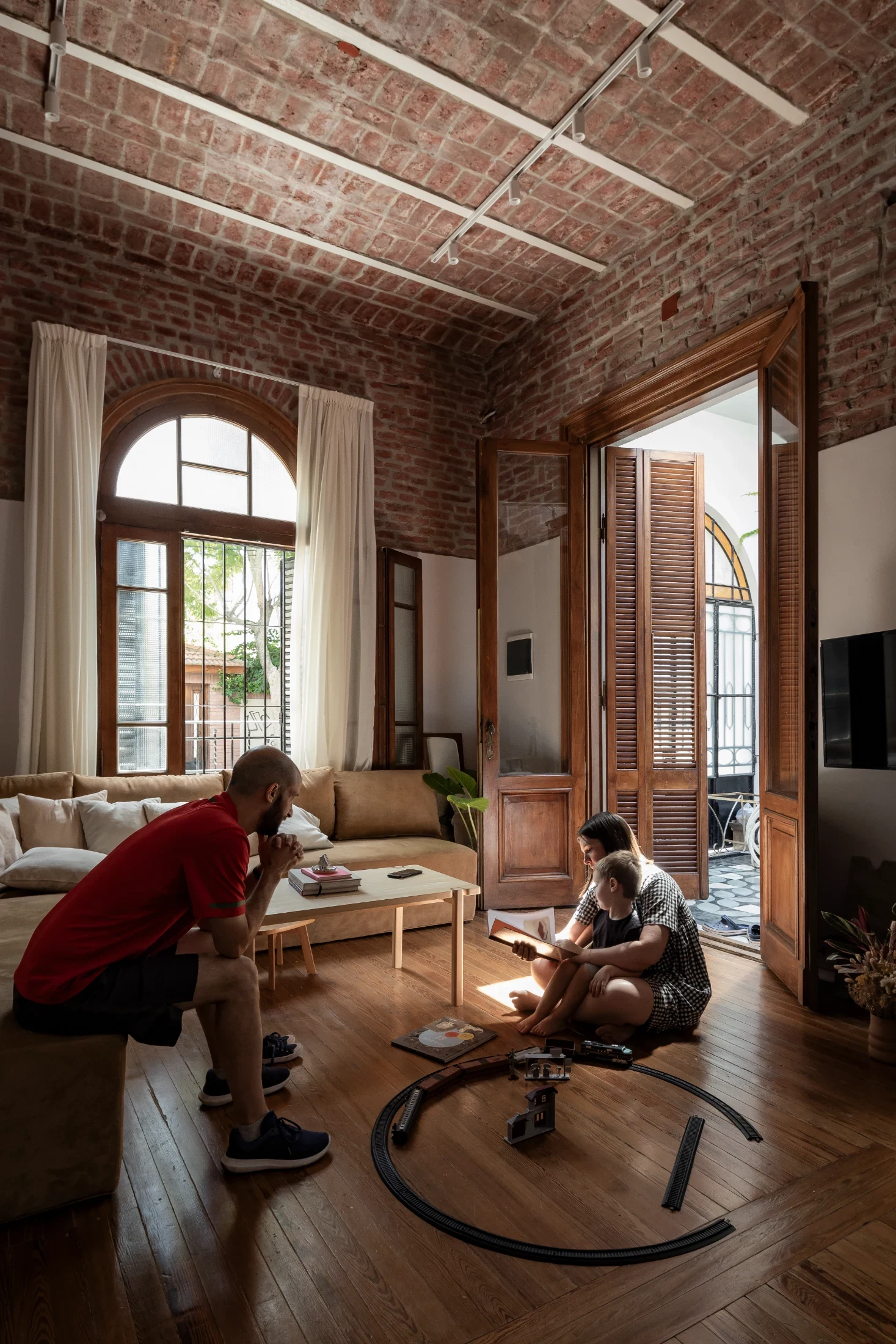 Juan and Laura with their son, Pedro. Laura and Juan worked to retain and restore every original feature they could including the original cedar doors, pine floors and the 'bovedilla' exposed brick ceiling.