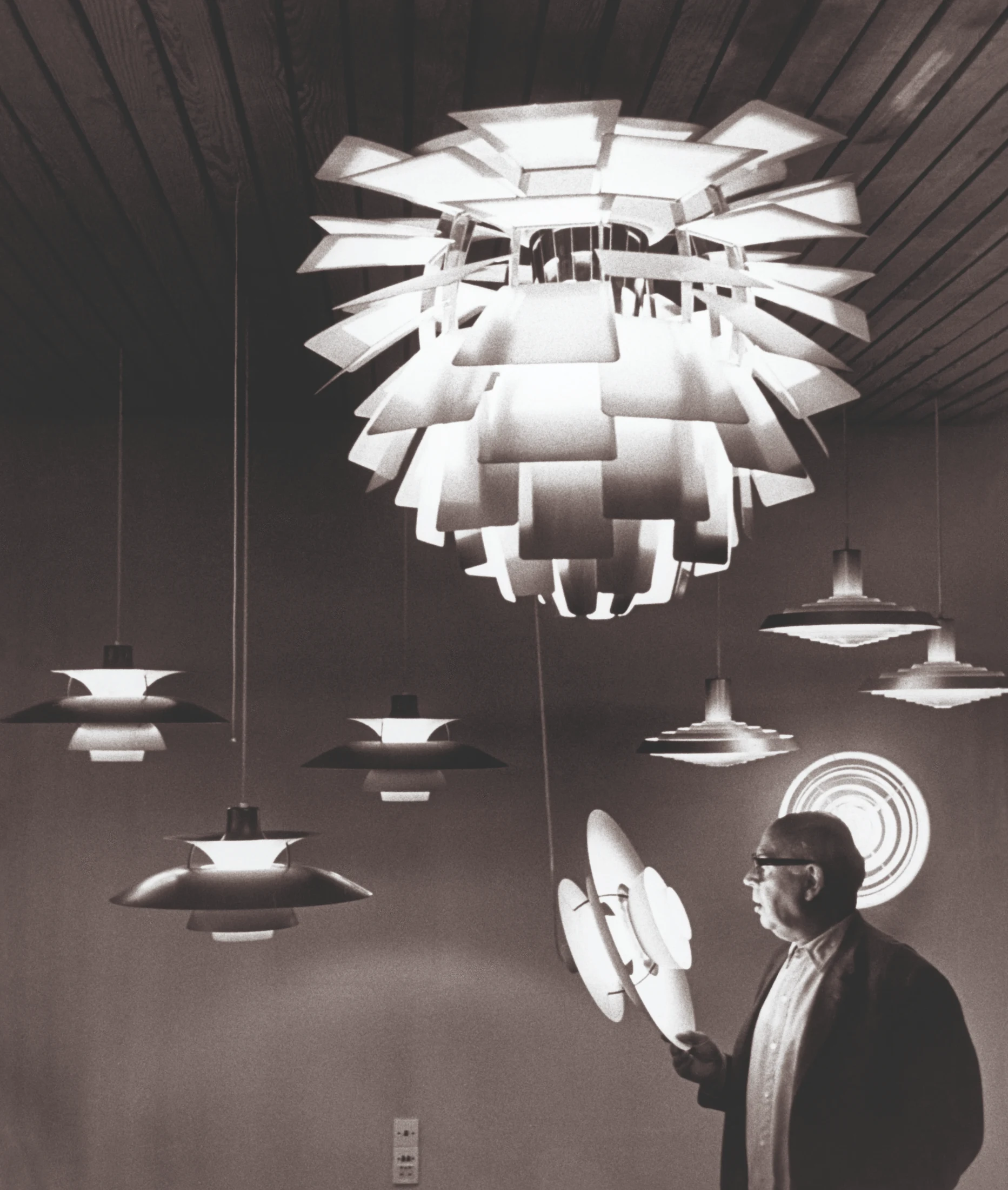 Poul Henningsen with his PH 5, PH Artichoke and PH Plate lamps, all launched in 1958. Image: Courtesy and copyright © Louis Poulsen.