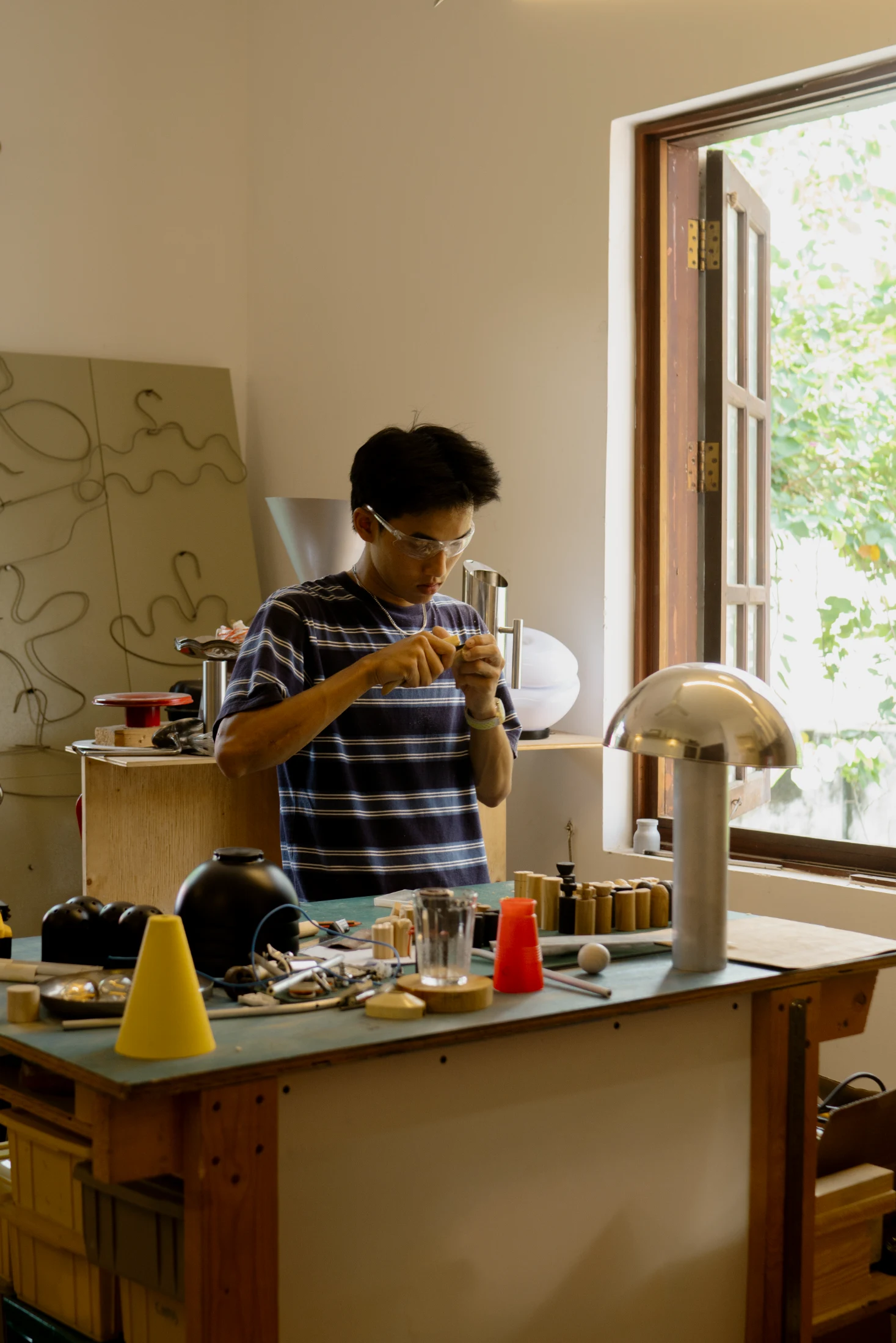 An working from the Ném Space workshop. An is a new 'maker/skater' at Ném Space where his previous showcased work includes a collection of products using reclaimed skateboards.