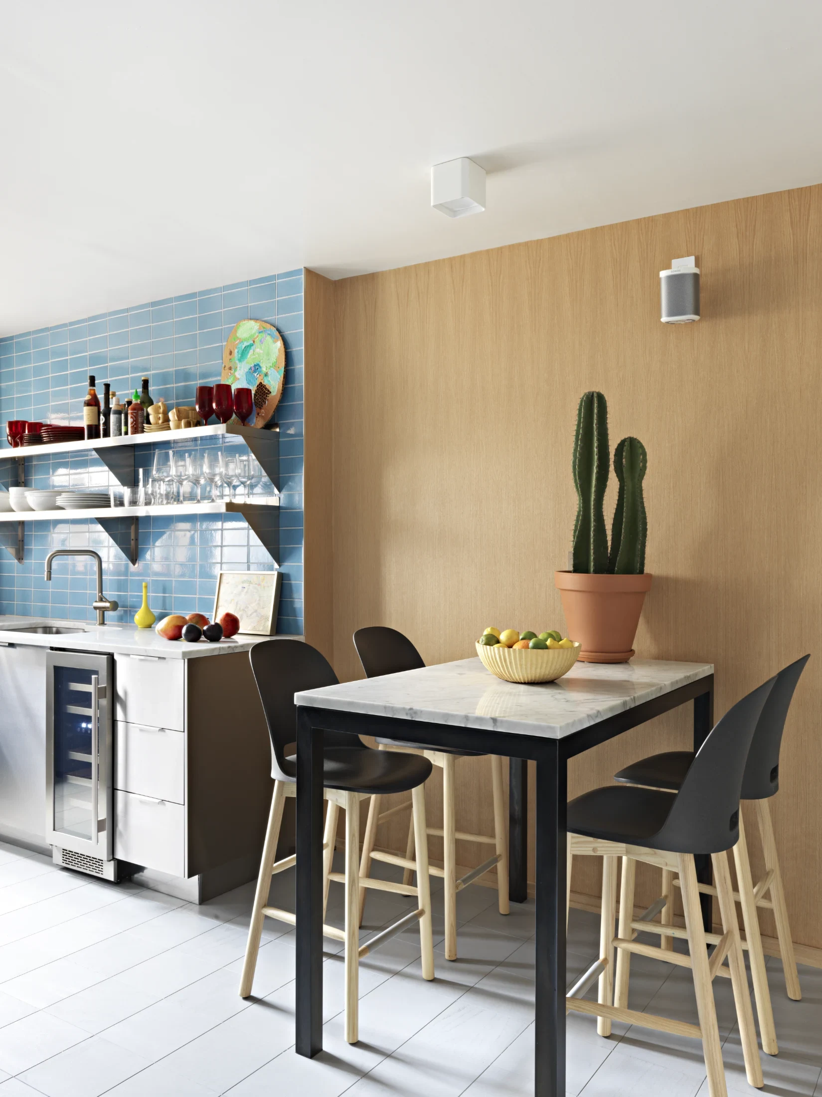 The kitchen design is relatively sedate compared to the rest of the apartment with the blue tiled splashback (chosen by Doug's husband, Meade) offering the sole pop of colour.