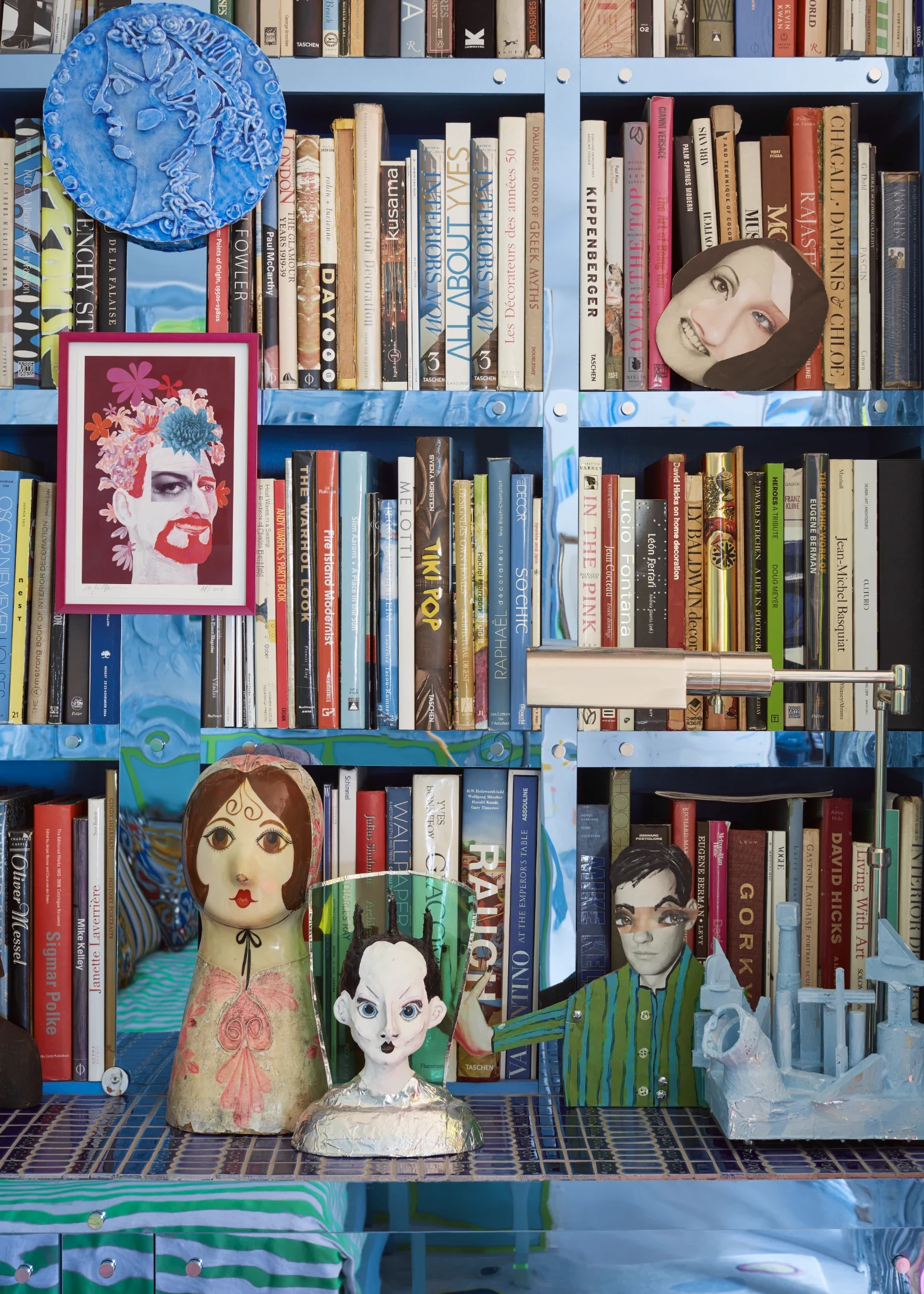 The custom bookshelves in Doug and Meade's library-cum-guest room are clad in mirrored Plexiglas. The custom wool rug, designed by Doug, is titled Lost in Air. The wall panels are another of Doug's creations and are made from glazed ceramic.