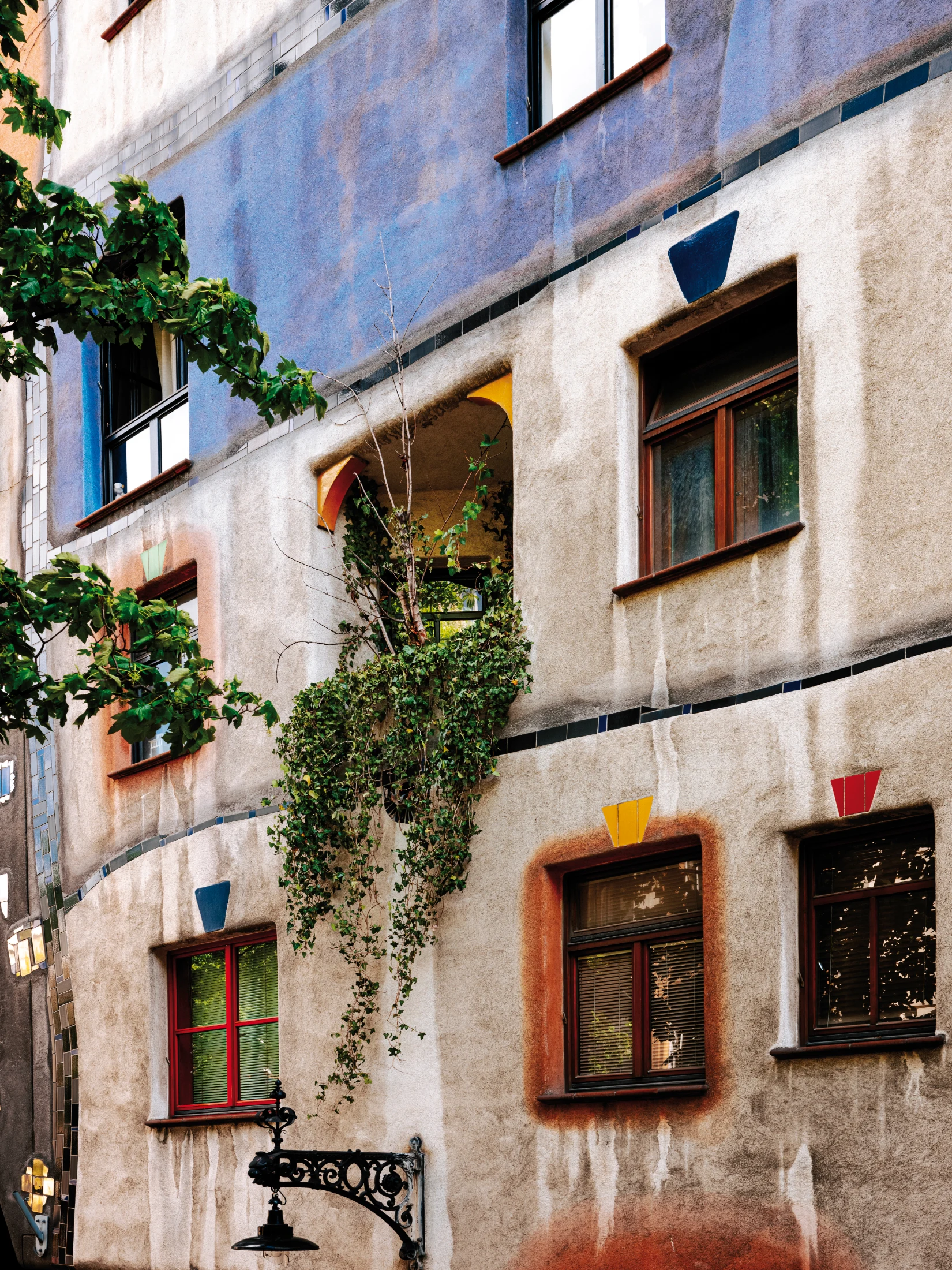 The building's 'tree tenants' feature in many of the building's balconies and decorate its brightly-coloured facades. Image: WienTourismus/Paul Bauer courtesy of the Vienna Tourism Board.