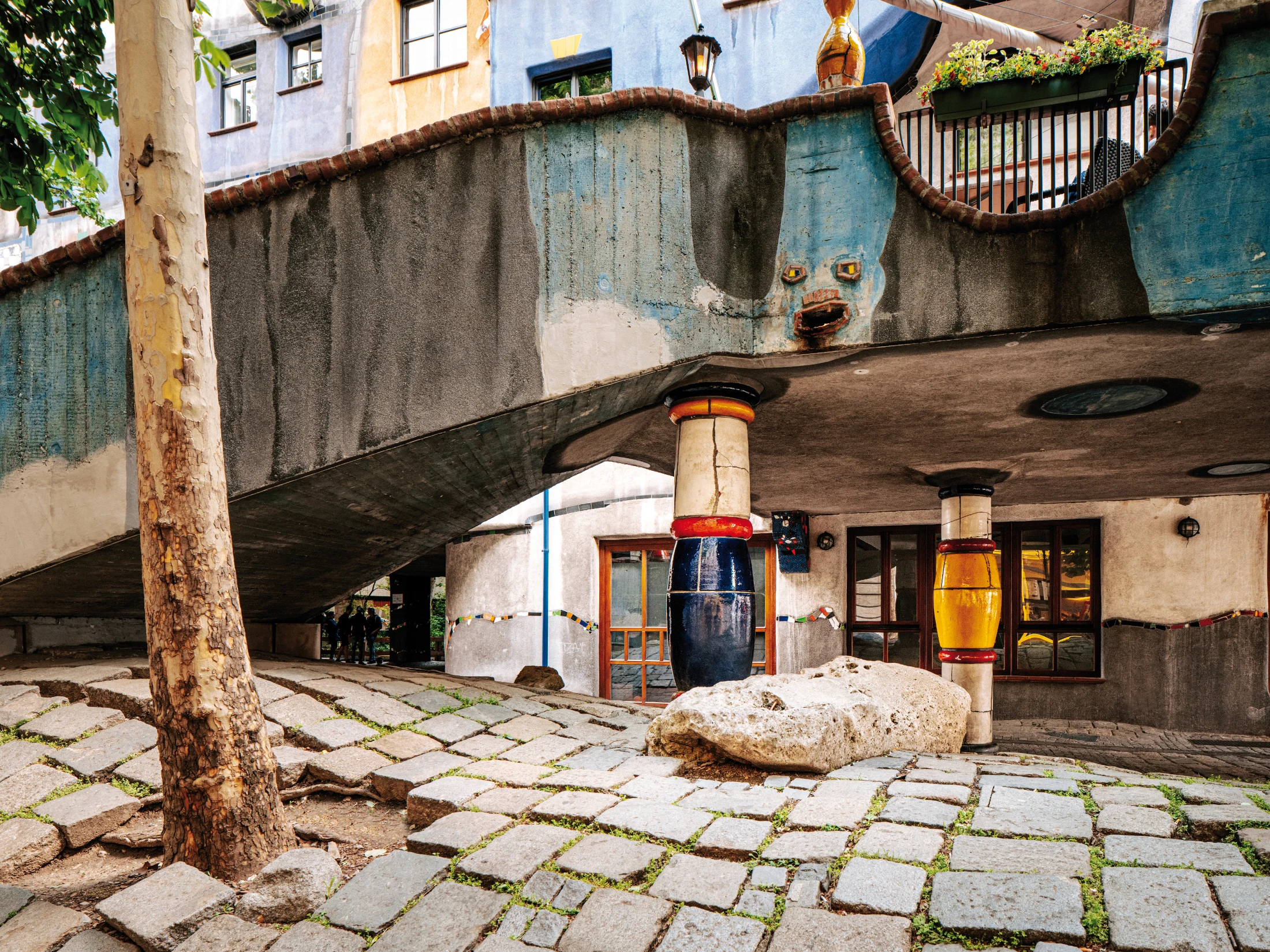 Colourful and peculiar little faces are found dotted around Hundertwasser House. Image: WienTourismus/Paul Bauer courtesy of the Vienna Tourism Board.