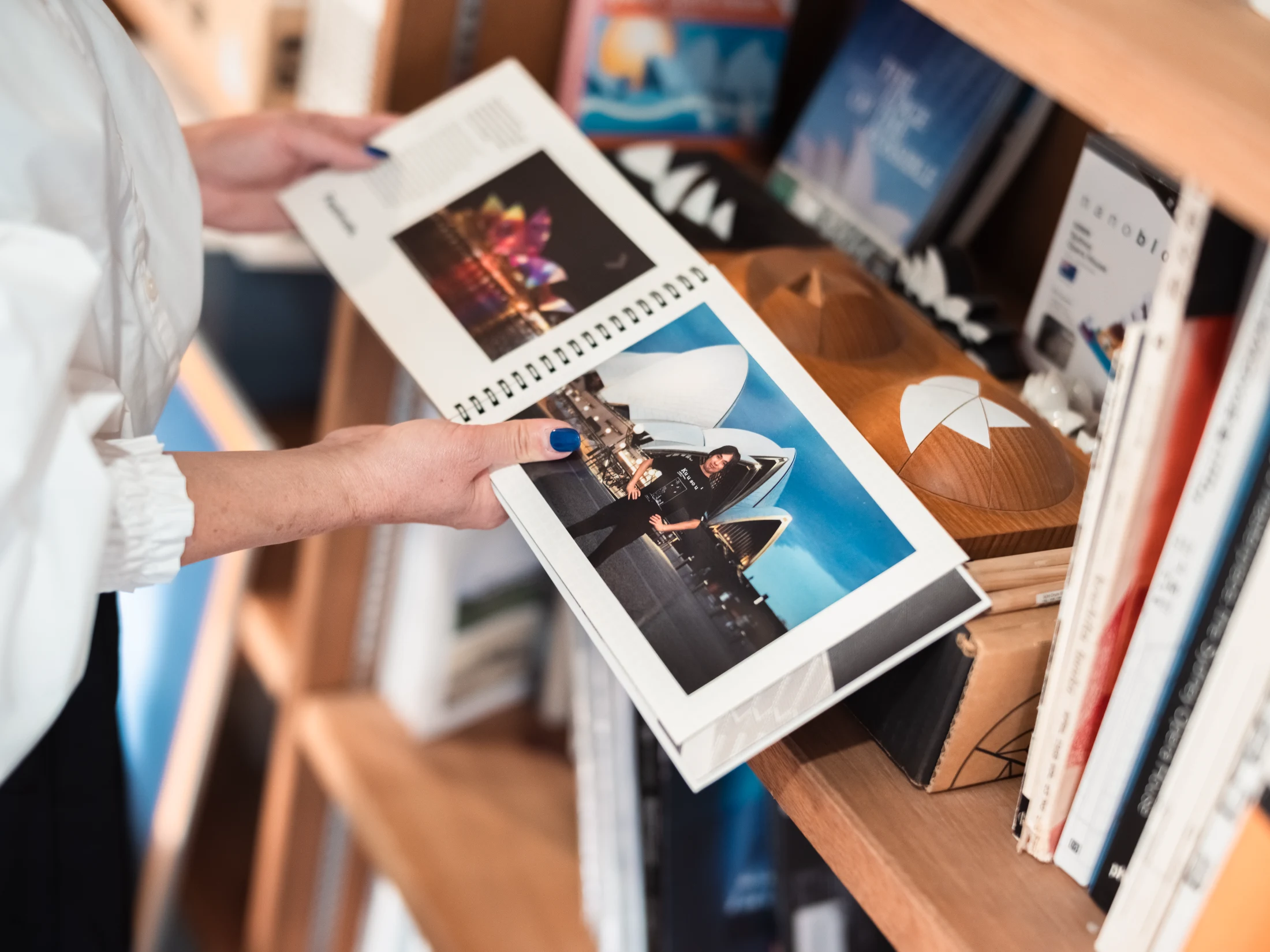 A photo book featuring an image of Takeshi in front of the Sydney Opera House, which he and Megumi spent three days exploring on a trip to Sydney. Images: Nam Tran.