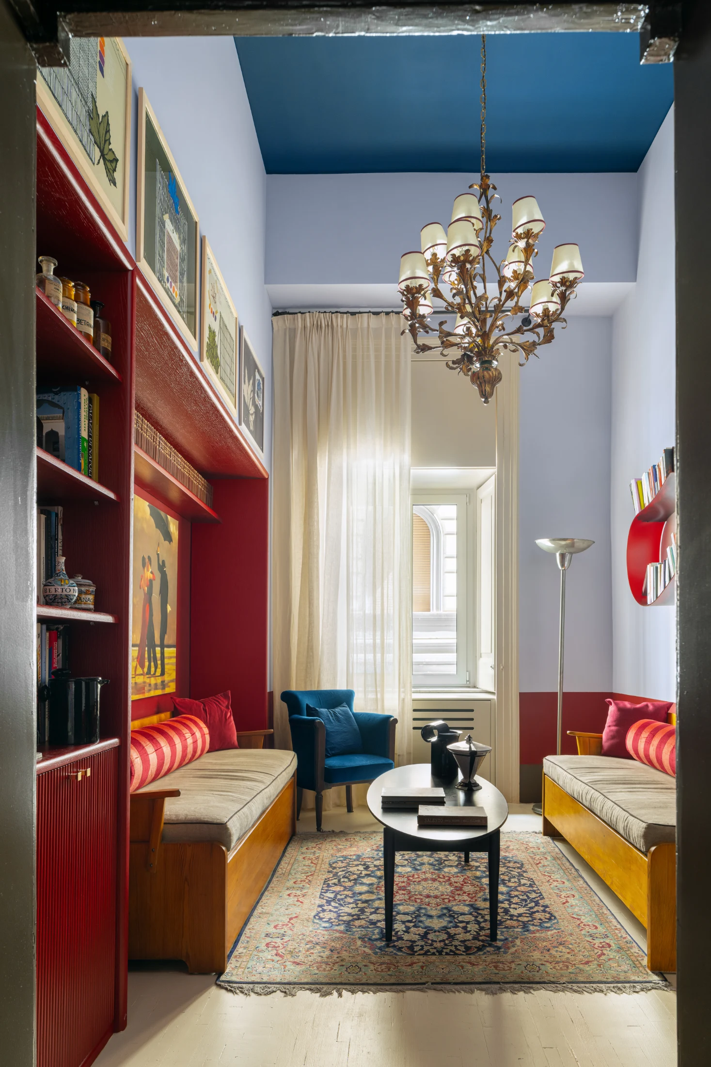 The apartment's living space doubles as a waiting room. The light-filled and ornately decorated room features a 1920s Florentine chandelier and a pair of sofas designed by Göran Malmvall from the 1940s.