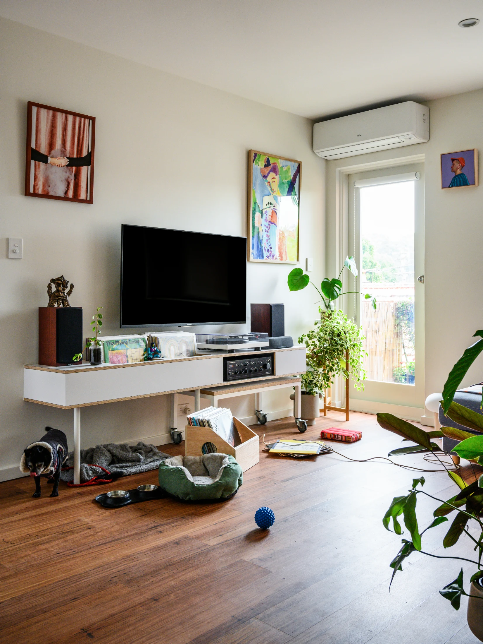 The custom media unit in the living room features bespoke storage for the couple's vinyl collection and amp and a pull-out coffee table. These photos were taken back in the days before dear Oscar moved to Vicki's mum's house.