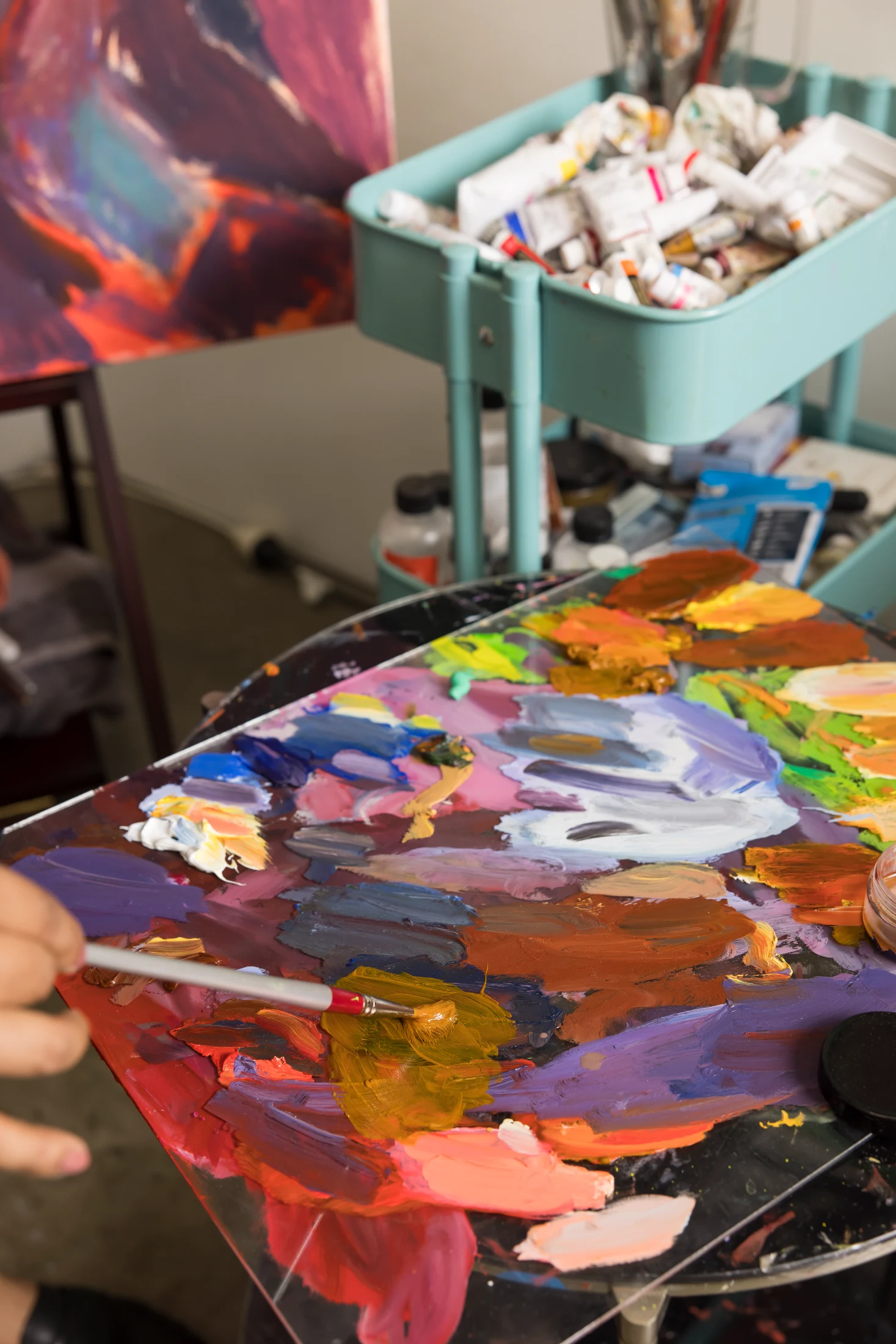 Details from Kirthana's studio space in Sydney including one of several portraits she has painted of artist, friend and mentor, Ramesh Mario Nithiyendran.