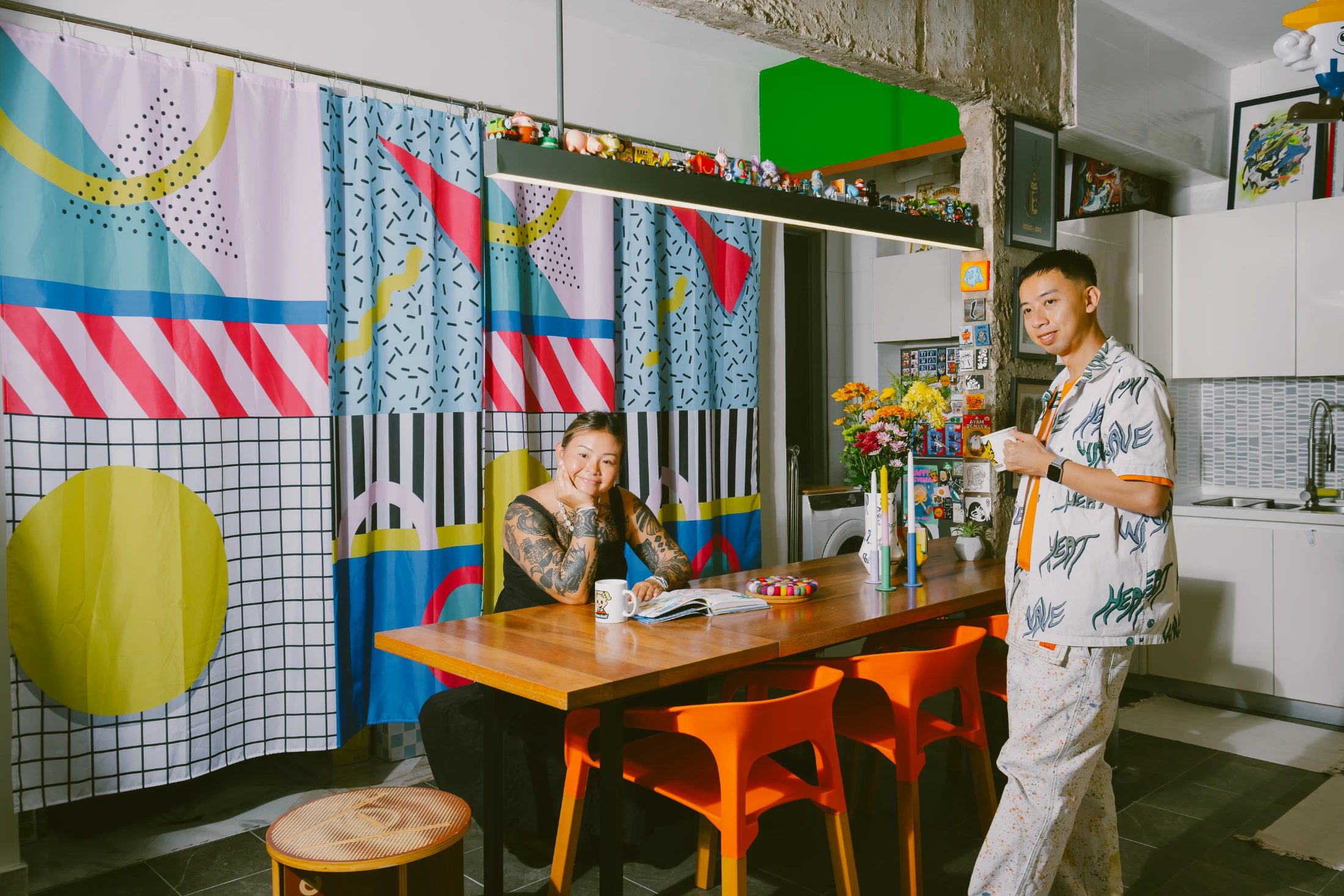 Chern and his partner Zoe in their colourful kitchen and dining space. Image: Auni Athirah Azmi.