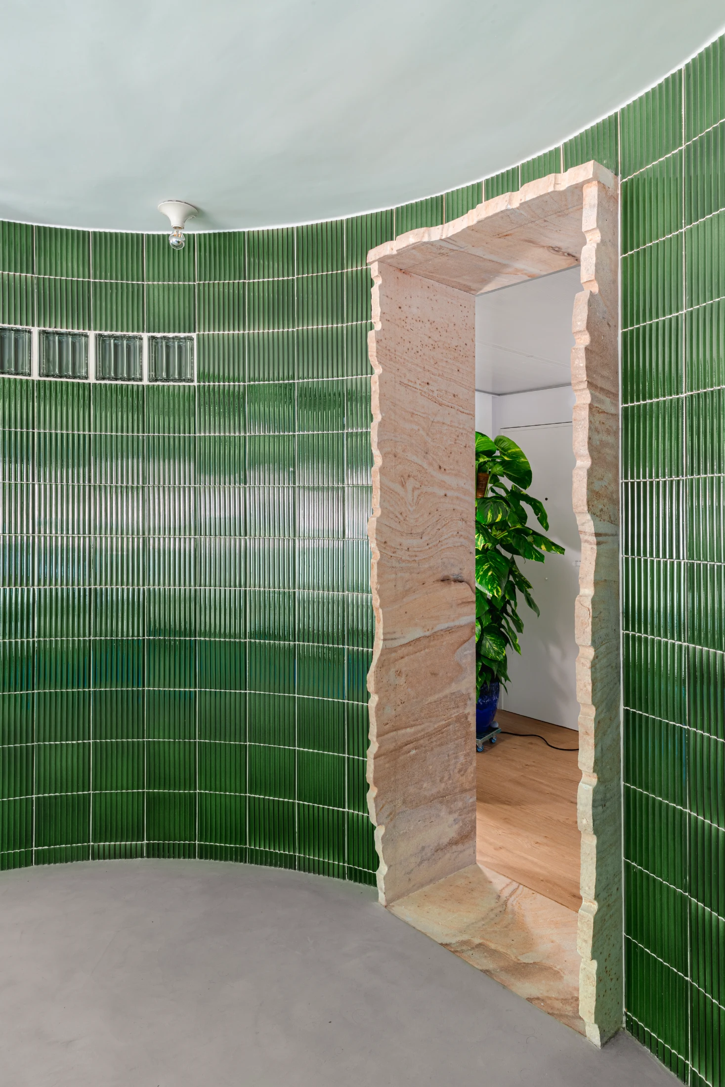 Sourced sustainably, the sandstone threshold's raw and unpolished texture highlight its natural extraction process and the project's focus on utilising local materials. Image: hiperfocal.