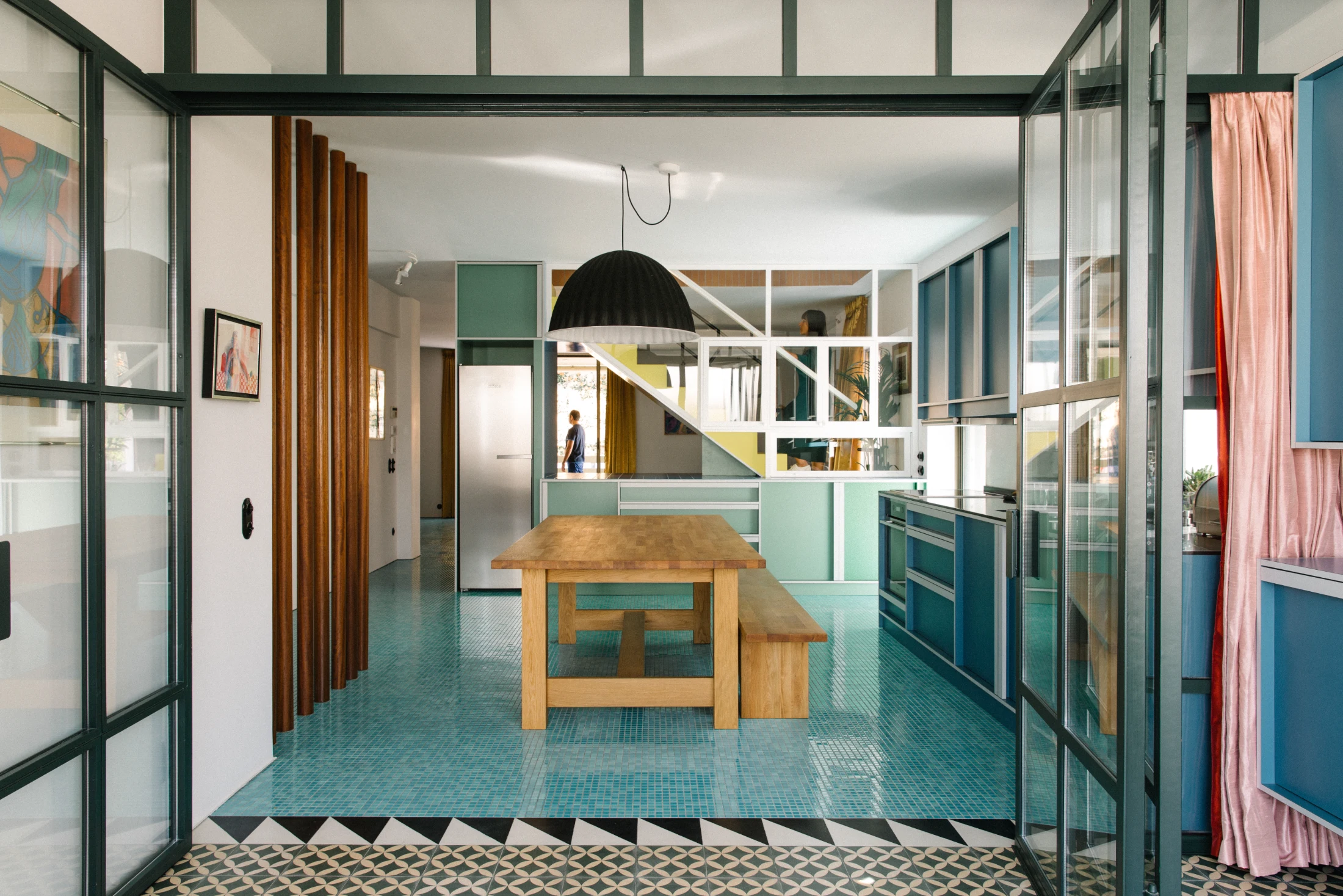 Transitions in flooring are signaled by strips of black and white tiles in Nadja apartment. Image: Yannis Drakoulidis.