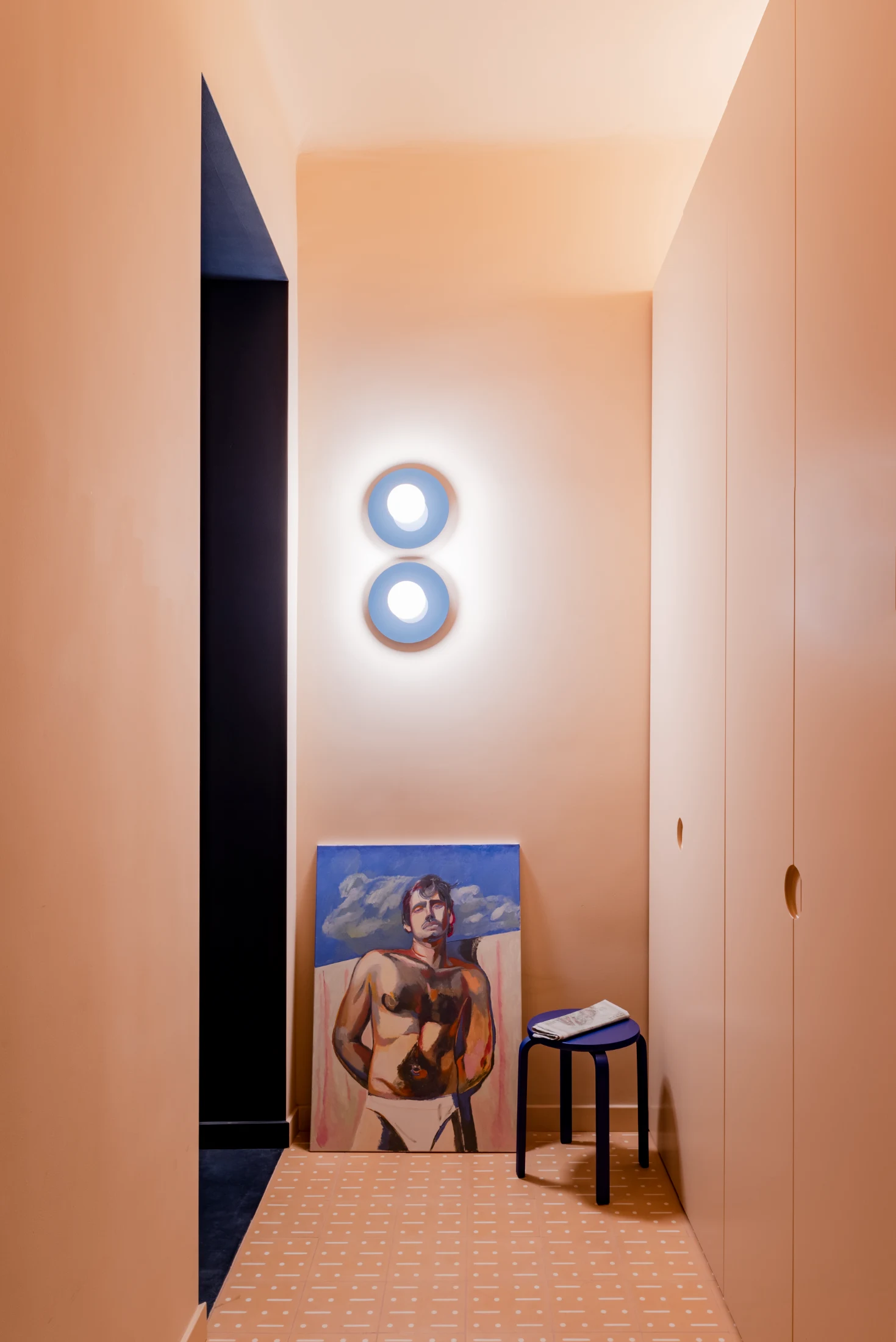 The entrance's warm and inviting tones are paired with custom-designed cement tiles produced by Mosaic Factory in London.