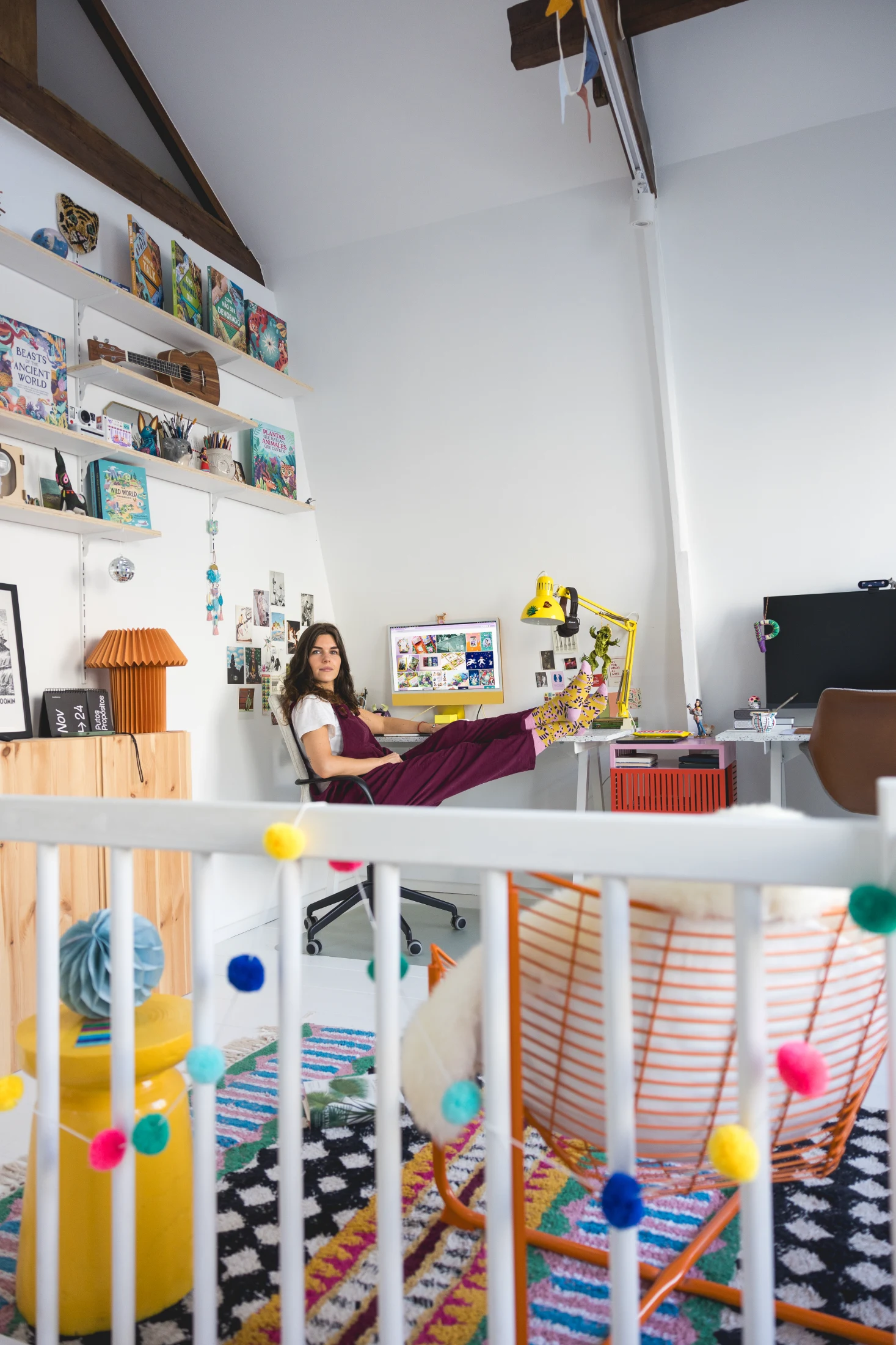 Asia pictured in her colourful and light-filled upstairs studio, surrounded by her illustrations and artwork.