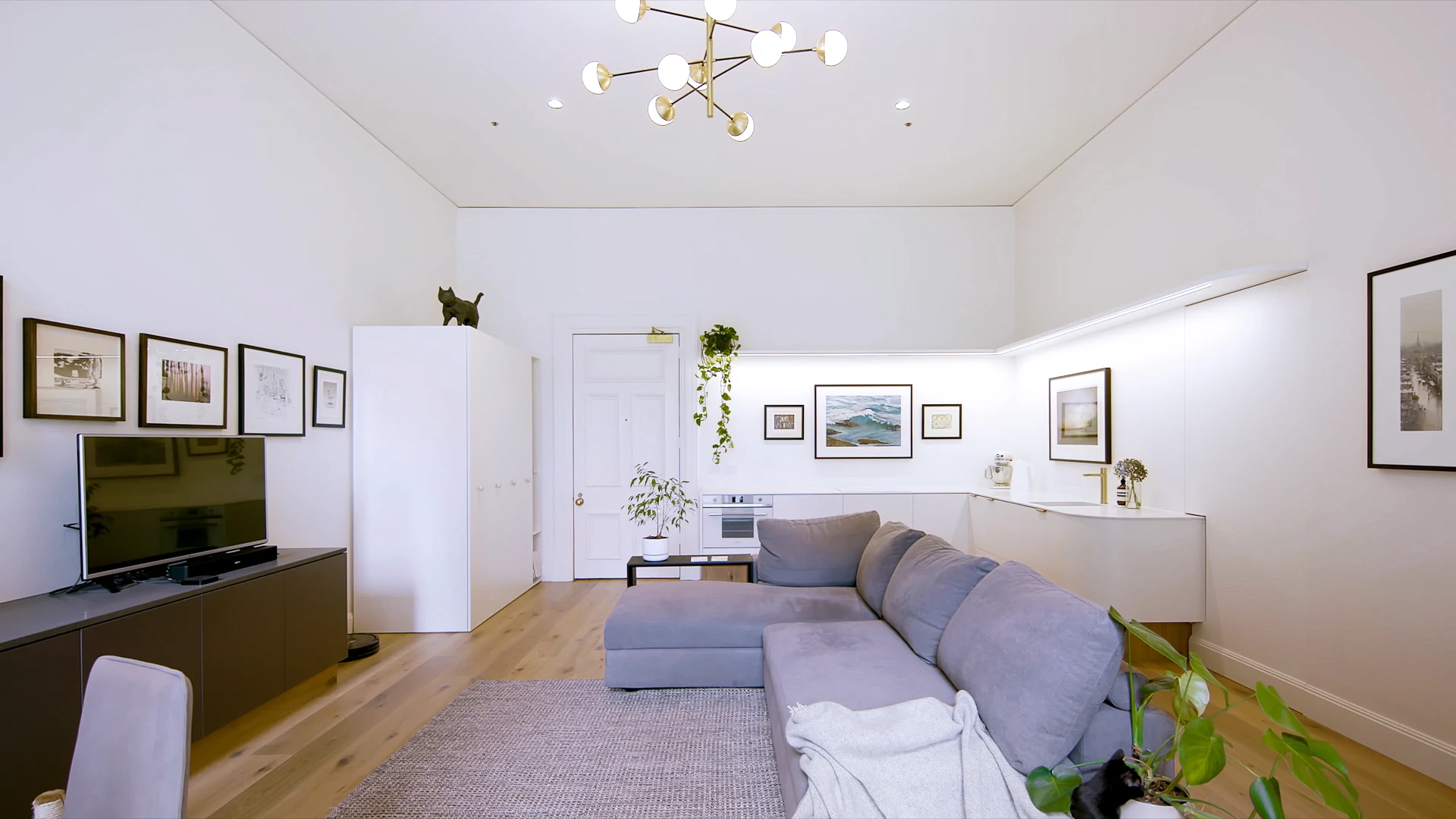 Designed to be discrete and recessive, the kitchen in Small Grand Apartment blends seamlessly into the living space. The design from Tsai Design's Jack Chen features a white induction cooktop and (predominantly) white oven that are almost camouflaged withi