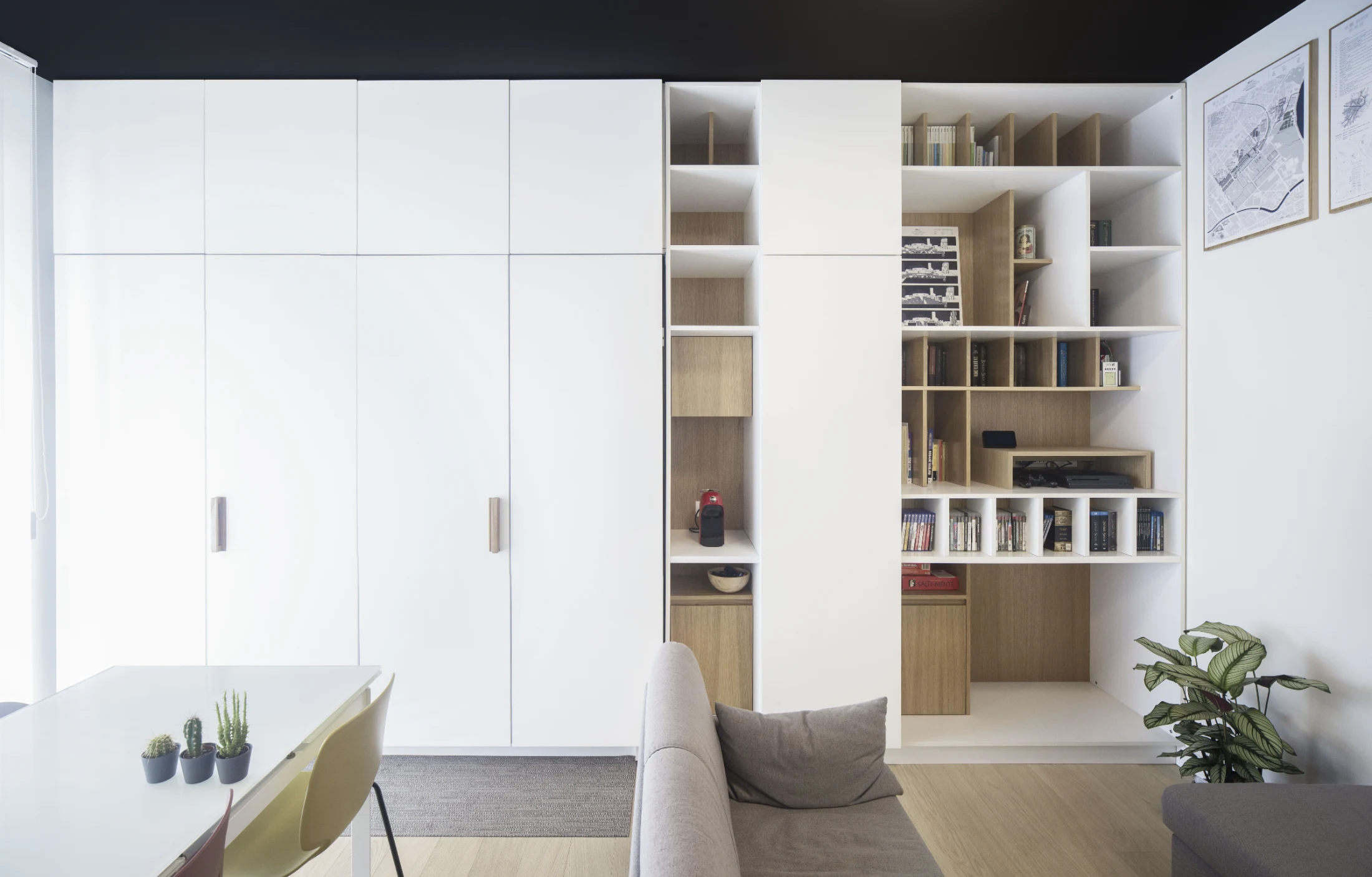 In Davide Minervini's Luini Apartment a series of bi-fold pocket doors cleverly hide the kitchen entirely when not in use, so it appears to be just an extension of the living room joinery.