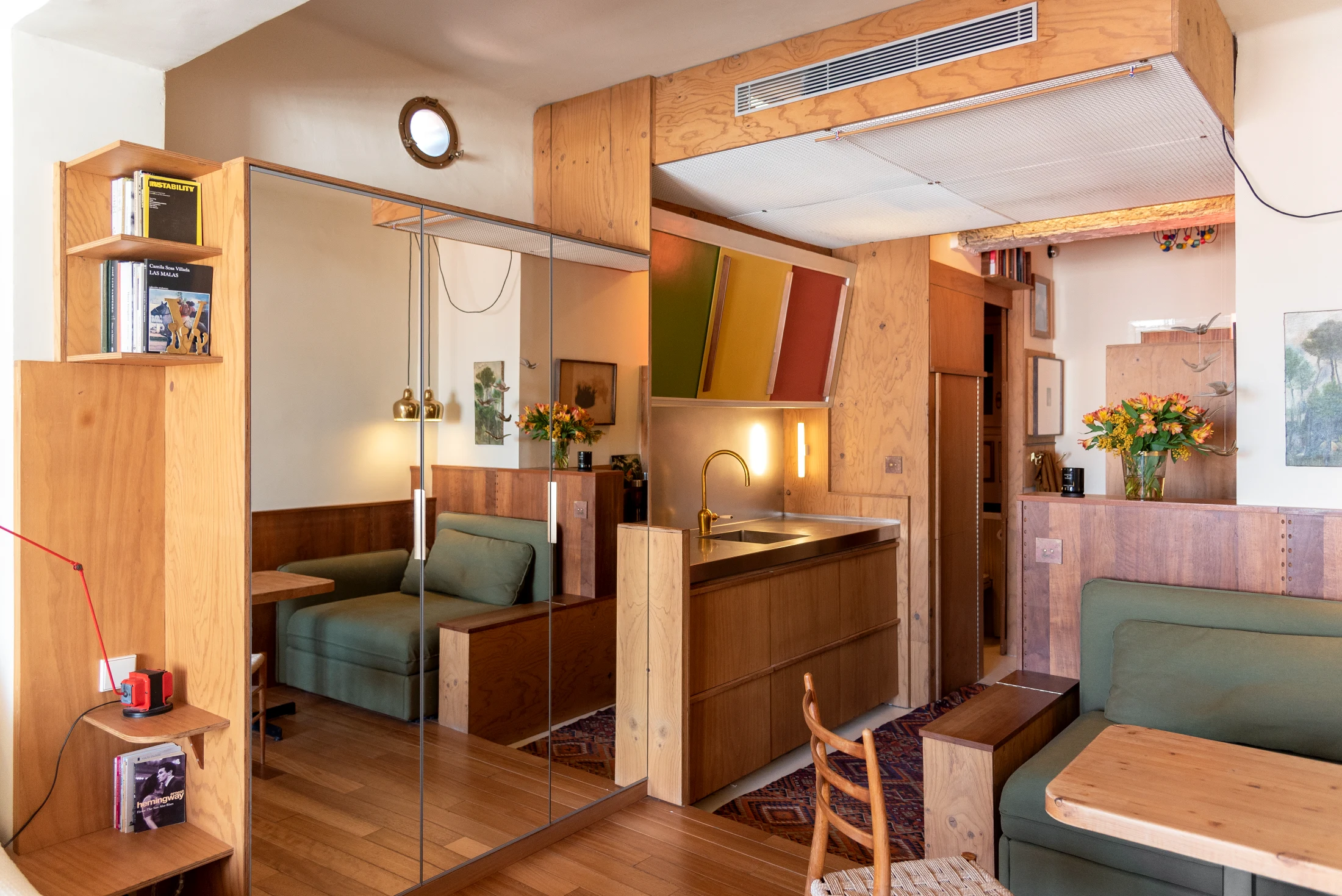 Architect and furniture dealer Jacobo Valentí of Casavells Estudio designed and built a one-of-a-kind kitchen for himself. It features IKEA kitchen cabinets that have been customised with dark timber door fronts and a colourful original mid-century cabinet