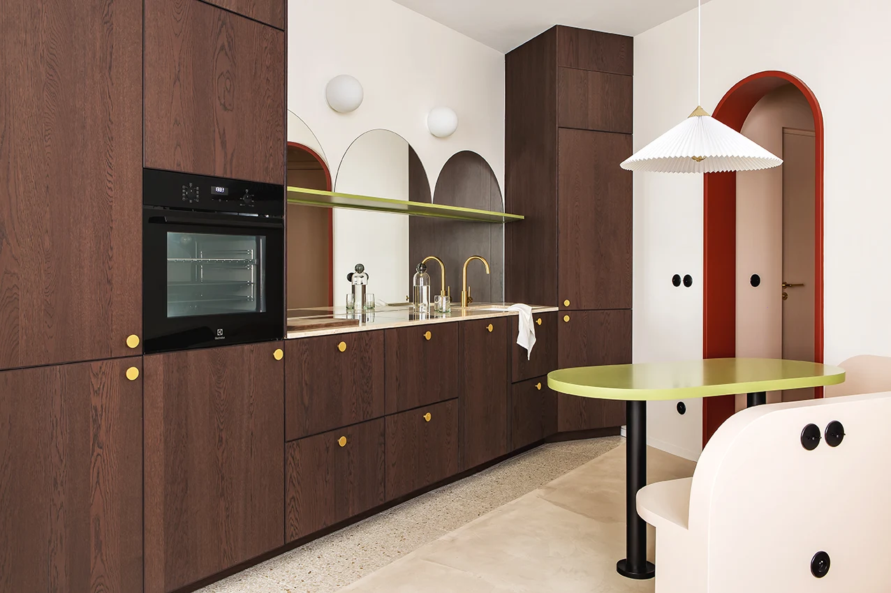 La Dolce Vita Suite designed by Space Factory features a single-wall kitchen with arched mirrors across its length, reflecting the surrounding light and enlarging the space.