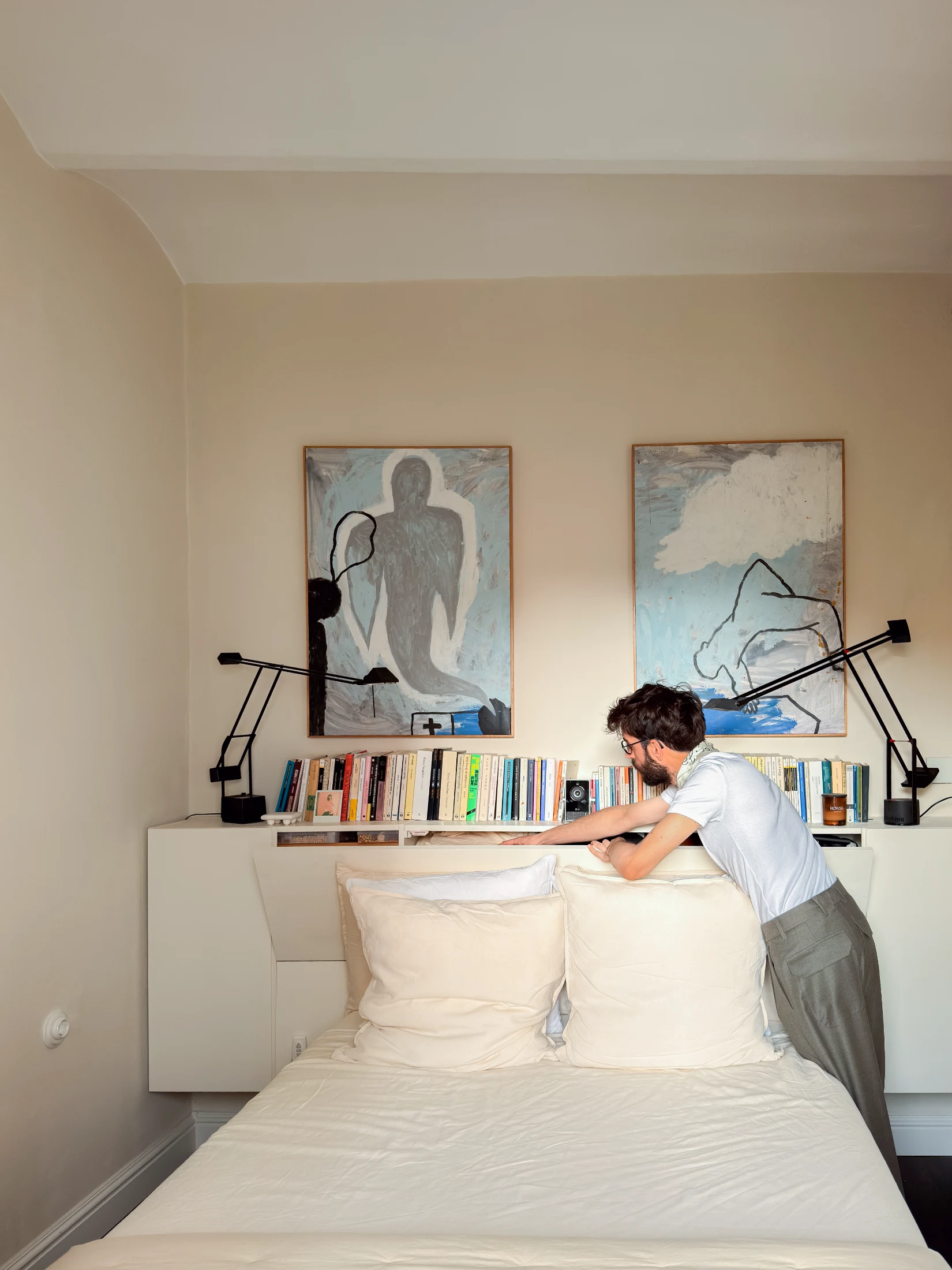 Storage space is cleverly integrated into the joinery that forms the bedhead in the master bedroom.