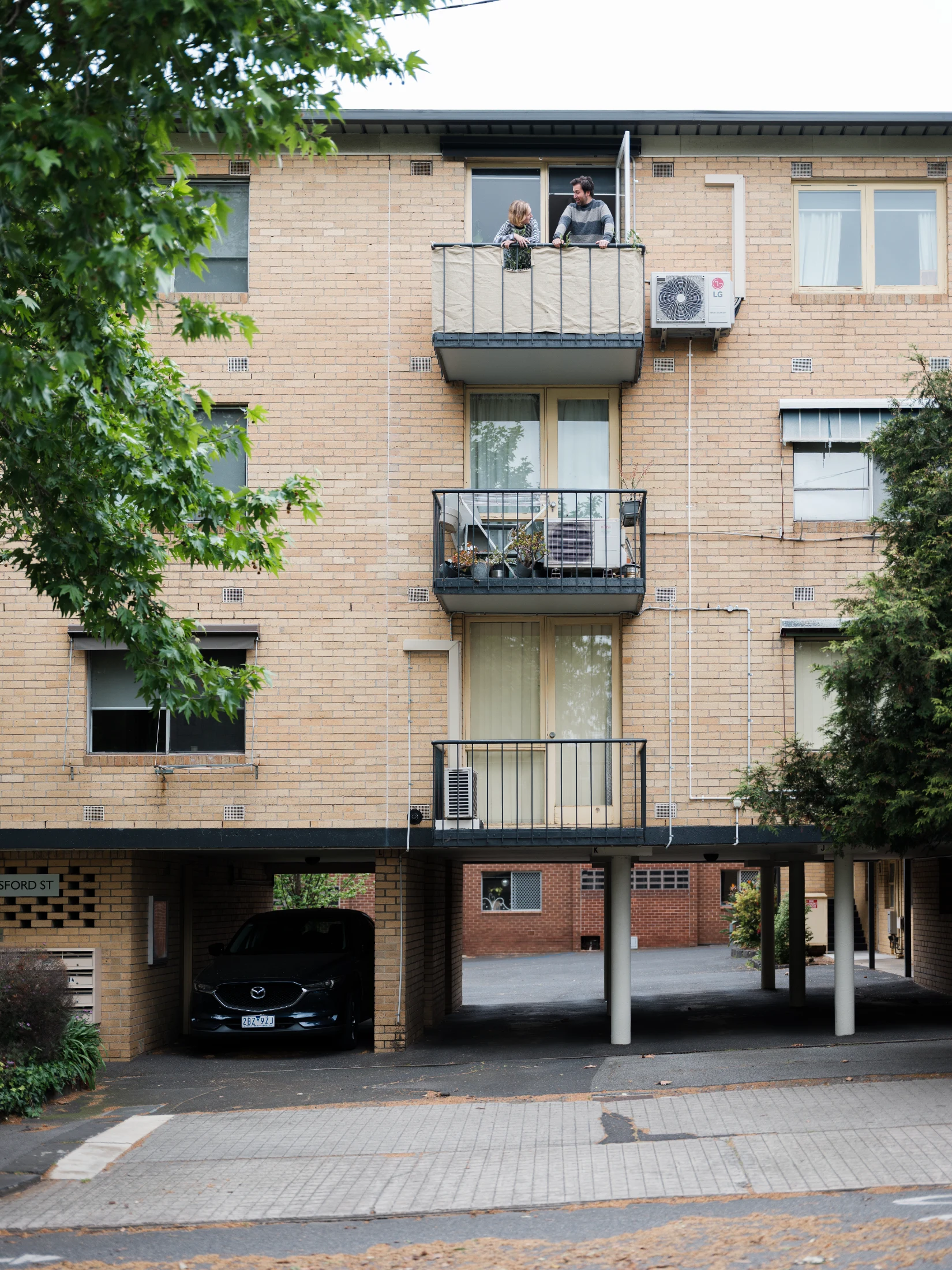 From the apartment's top floor balcony, Tahj and Sione enjoy long views over the city of Melbourne.