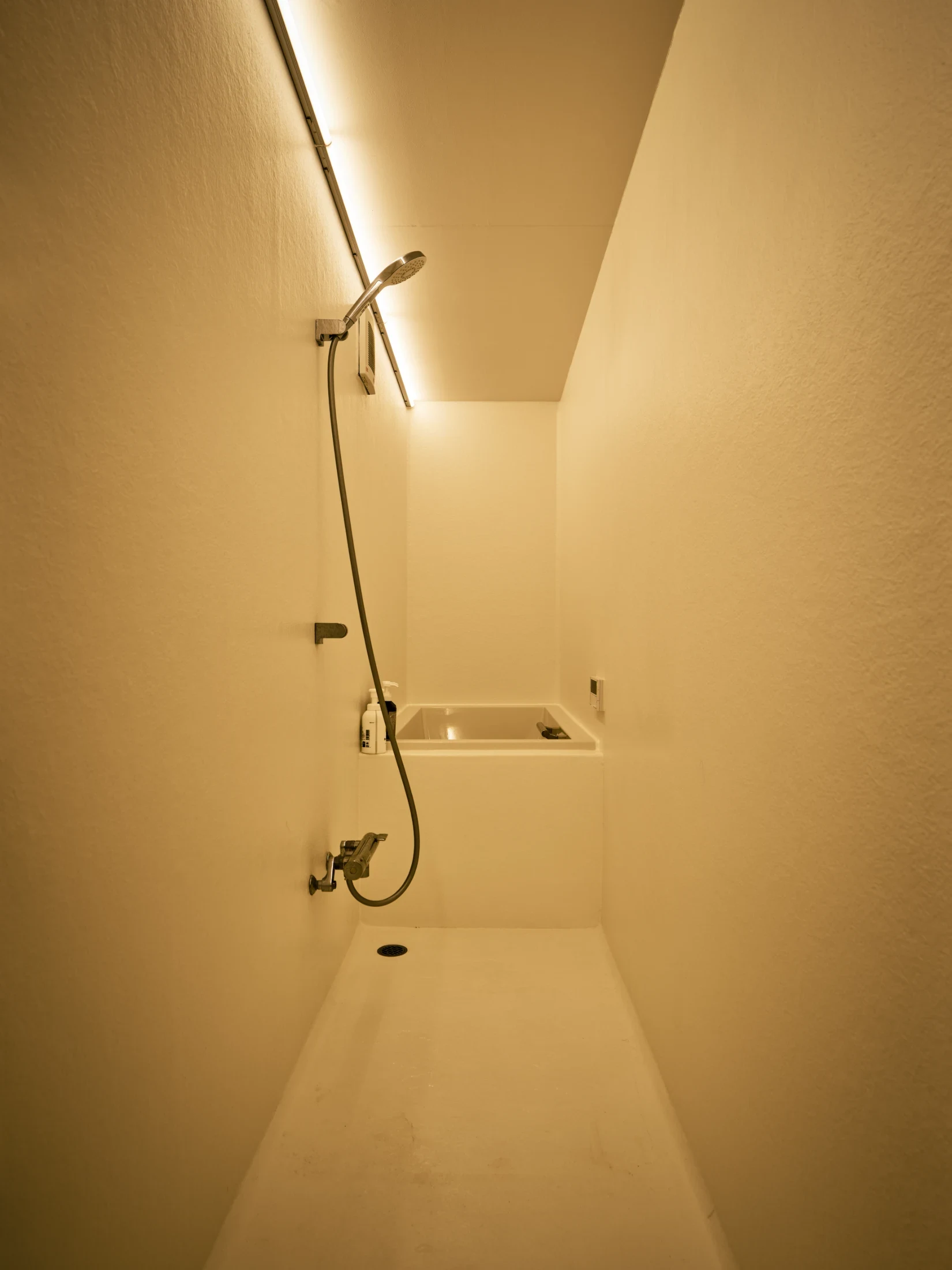 The enclosed design of the bathroom offers a significant contrast against the otherwise open and fluid spaces within the home.