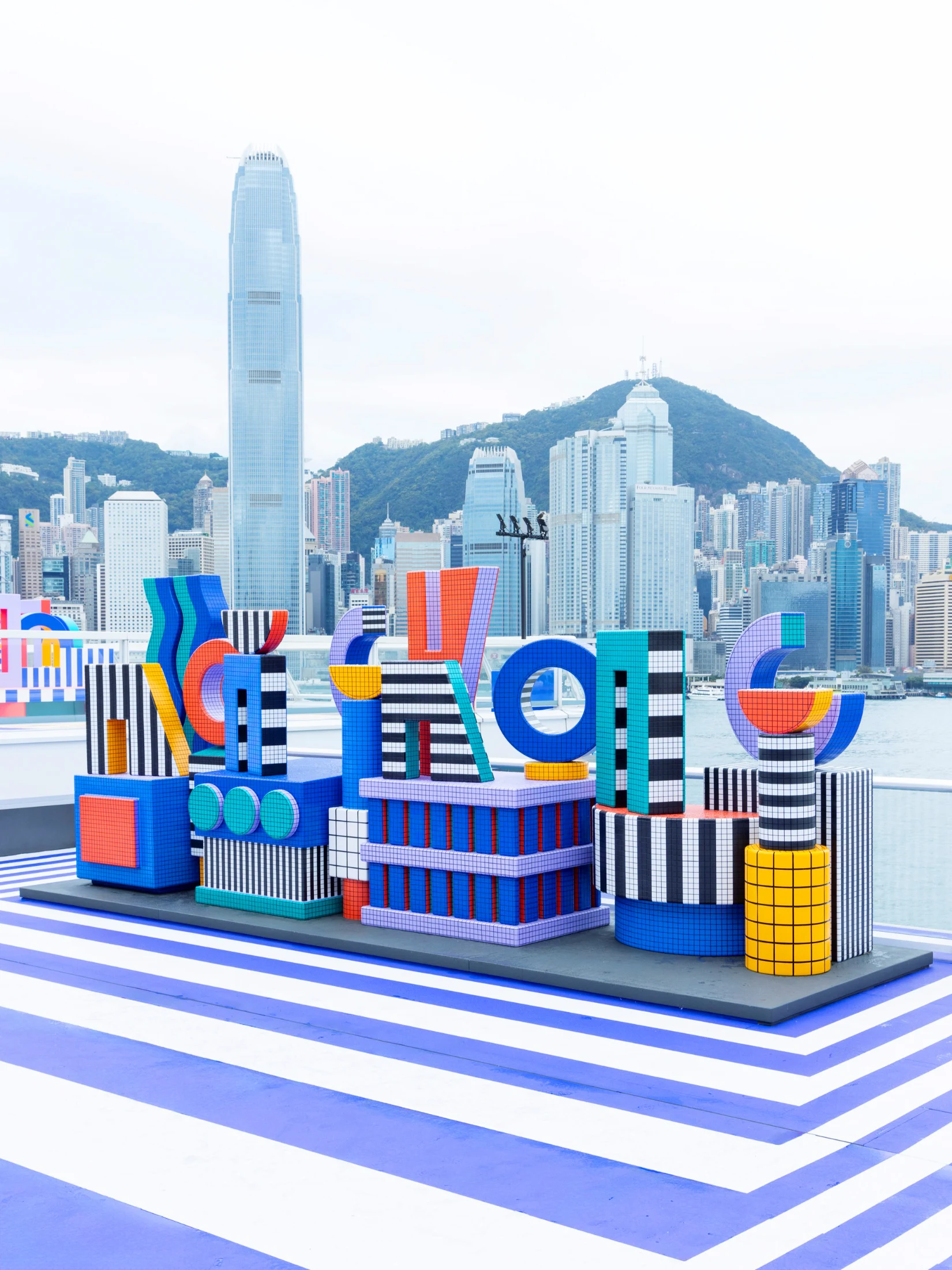 Overlooking the city skyline, the installation Now You See It, Now You Don't is an anamorphic Hong Kong city sign and art installation. Image courtesy of Harbour City.