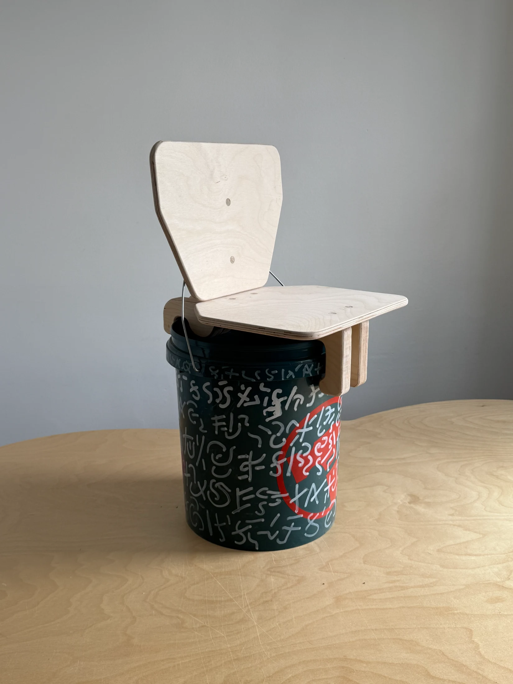 The Bucket Chair makes use of a common and inexpensive object for improvised seating.
