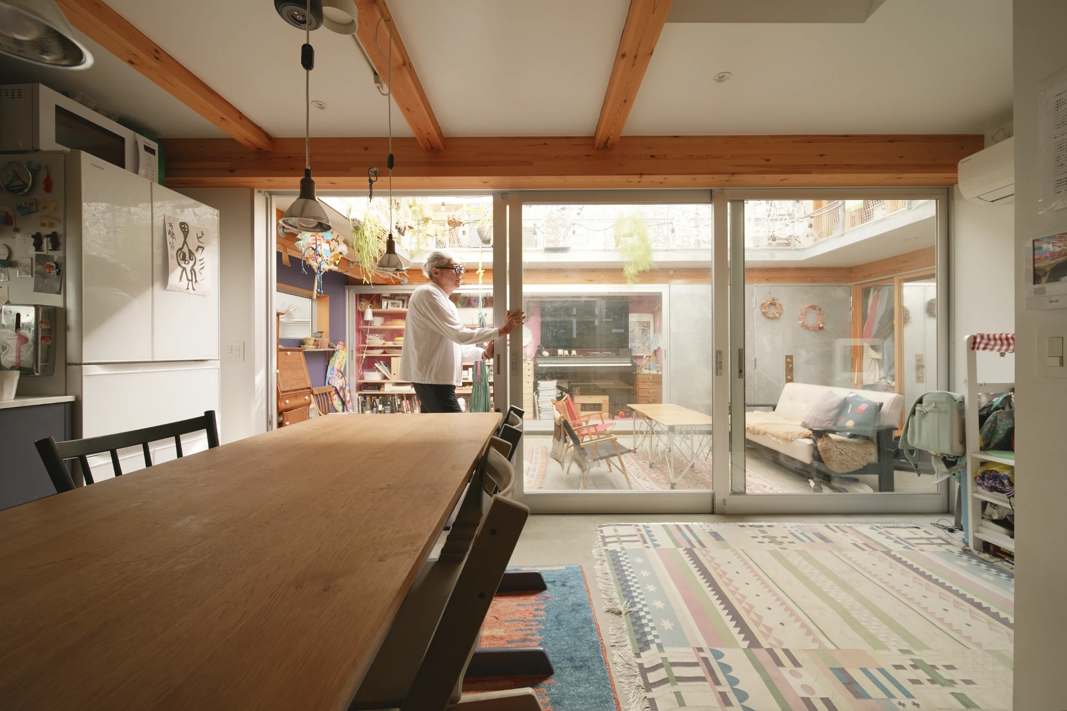 The large glass sliding door that divides the 'outdoor' living area from the 'indoor' kitchen and dining space can be fully retracted to integrate the two spaces.