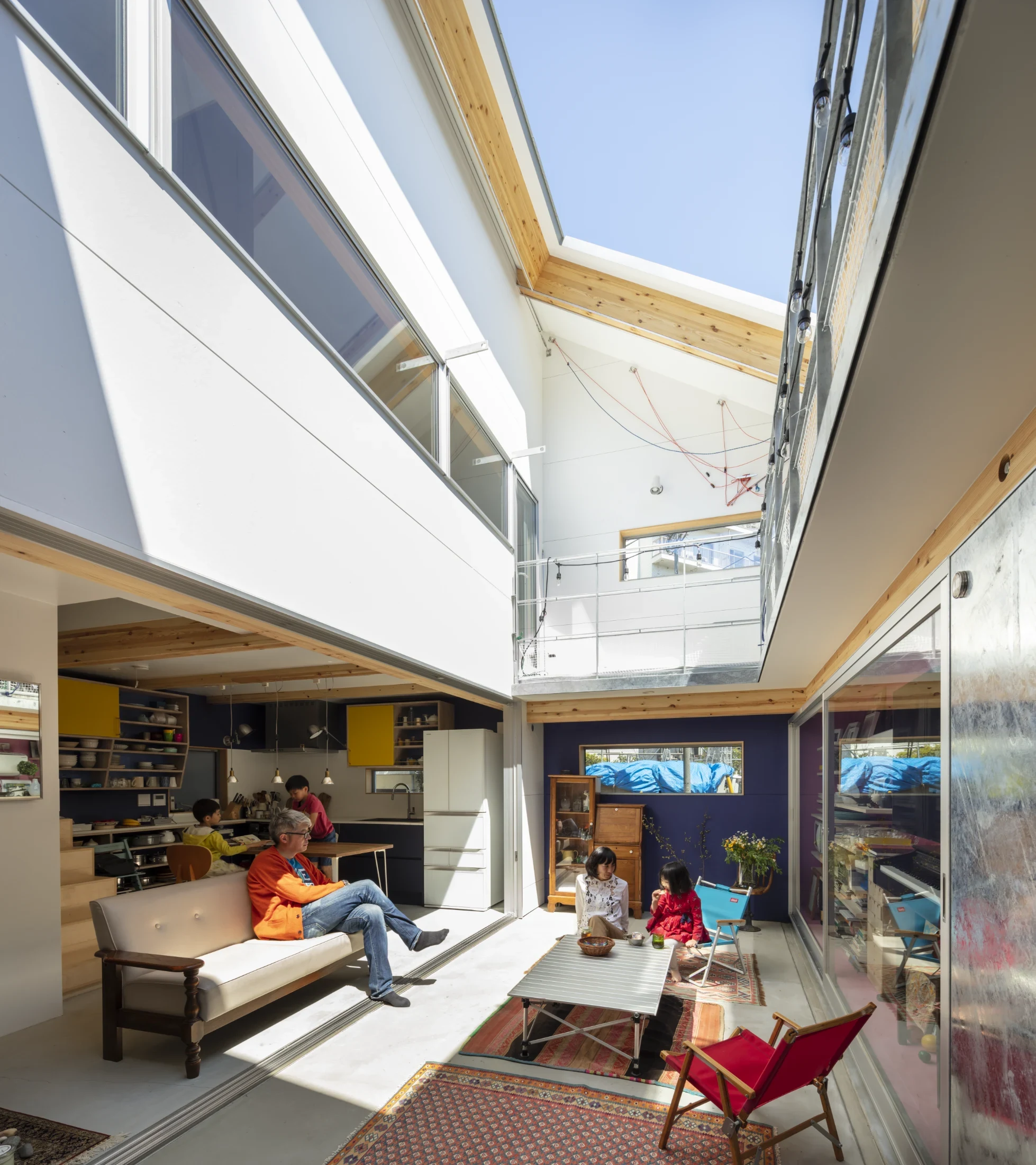 The open roof above the living area can be closed with a manually retractable sail-like tarp operated by a pulley system.