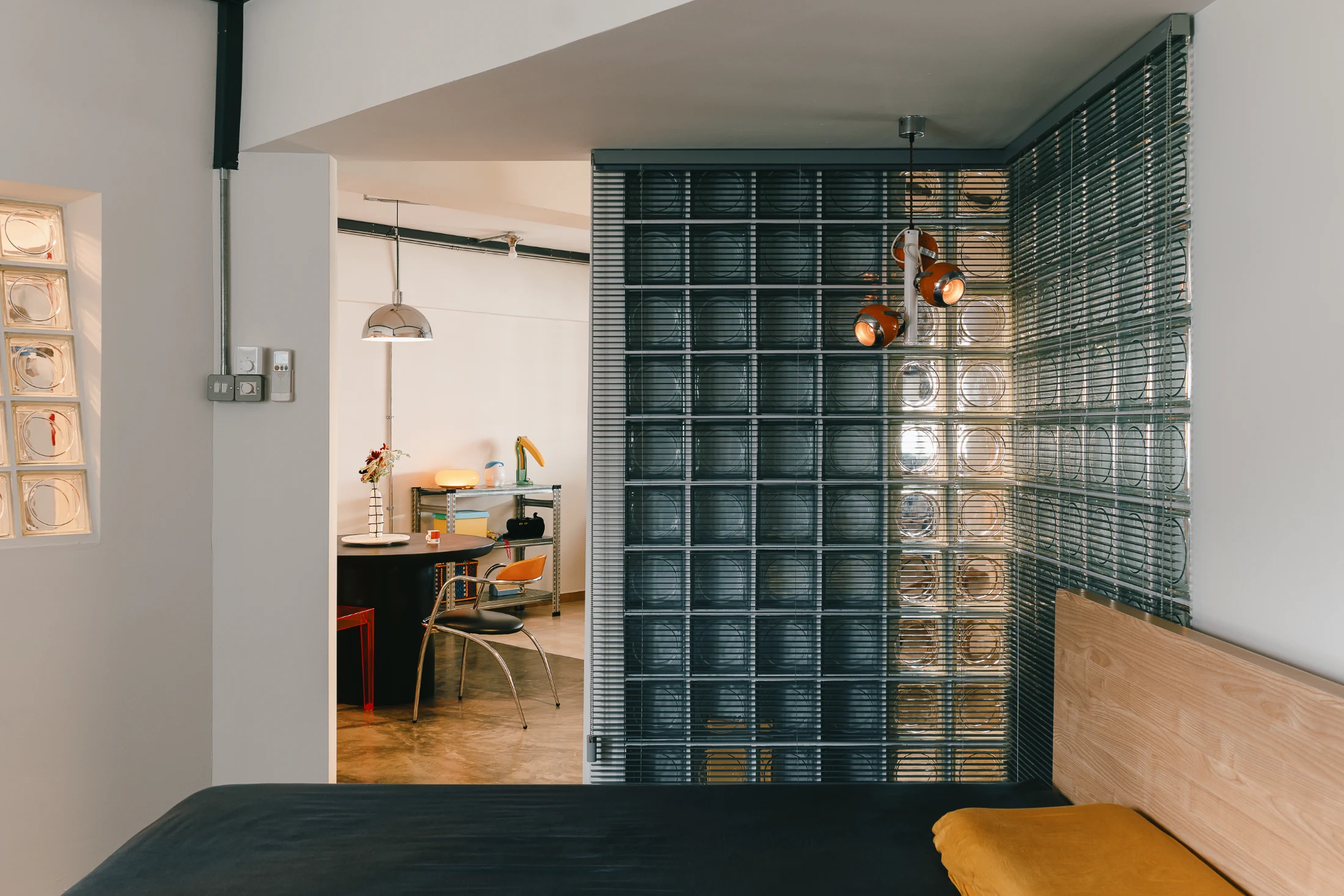 Venetian blinds installed on the inside of the glass blocks allow for privacy to be maintained within the bedroom.