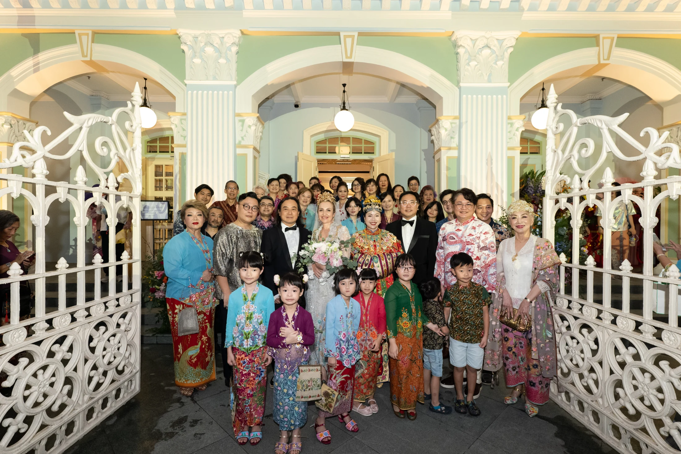 A Peranakan wedding ceremony with guests wearing traditional Kebaya dress. Image courtesy of the Peranakan Museum.
