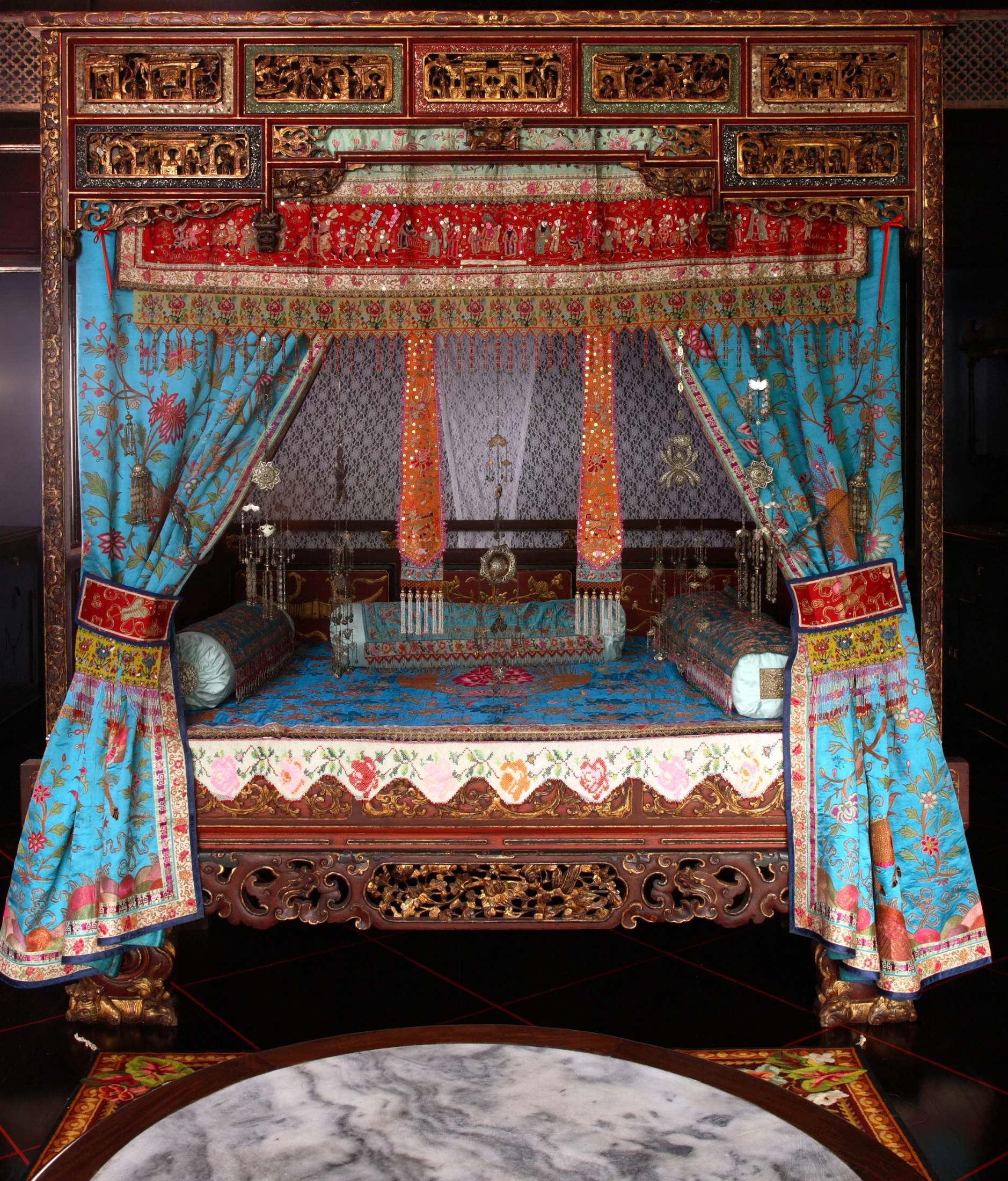 A traditional Peranakan Chinese bed, Peranakan House Museum, Singapore. Image: robertharding / Alamy.