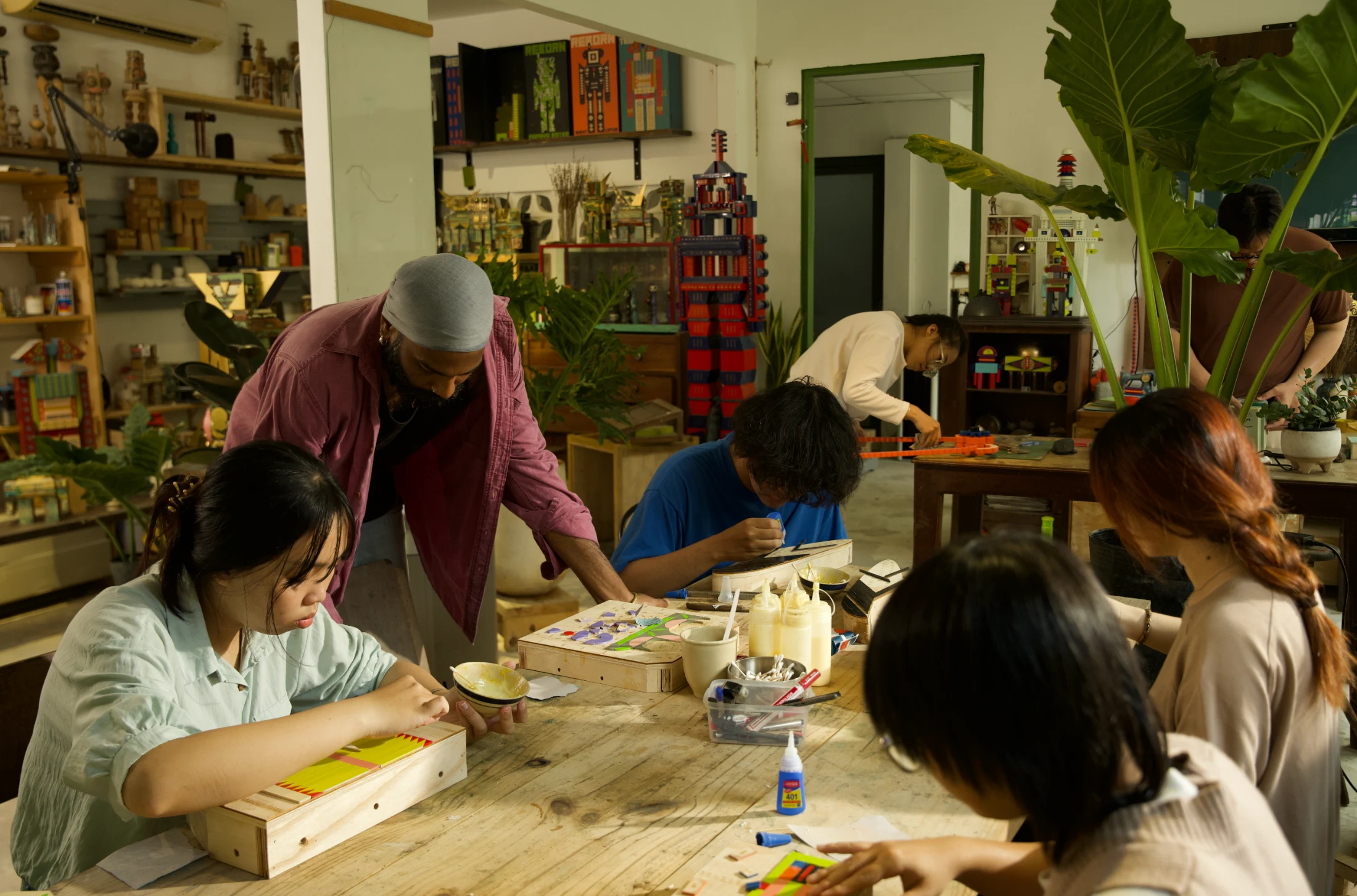 Kumkum in his studio and workshop space working with some interns and his studio assistant, Tue Nguyen. Image: Thuat Vo.