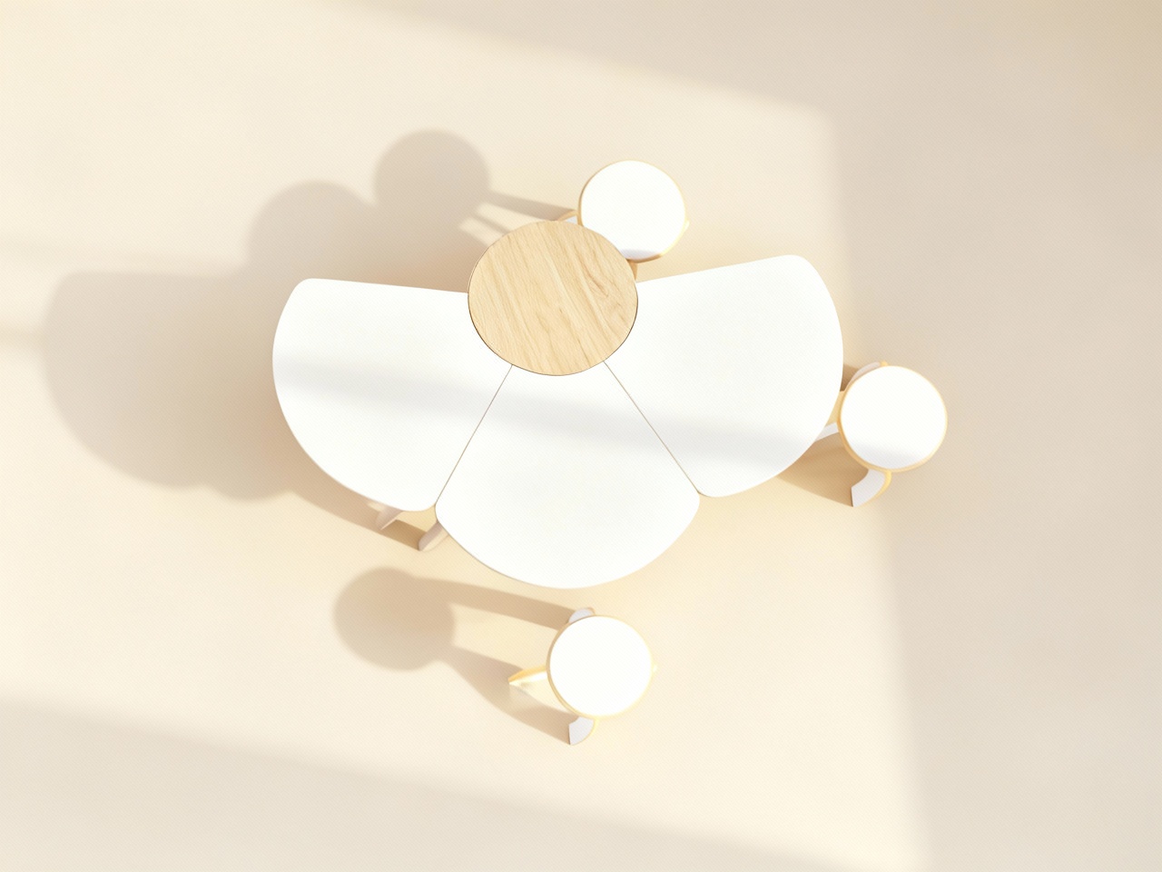 Overhead view of a modern white and light wood dining table with four round white stools casting shadows on a beige floor.