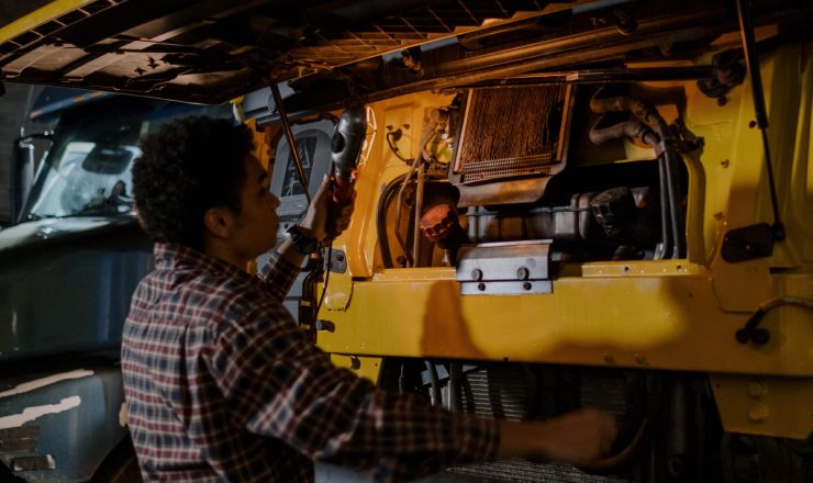Mechanic inspecting a commercial truck HVAC system