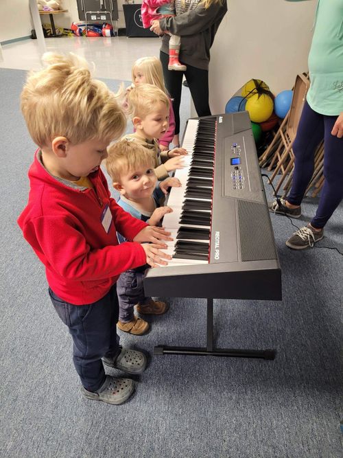 A man holding a guitar and playing a song
