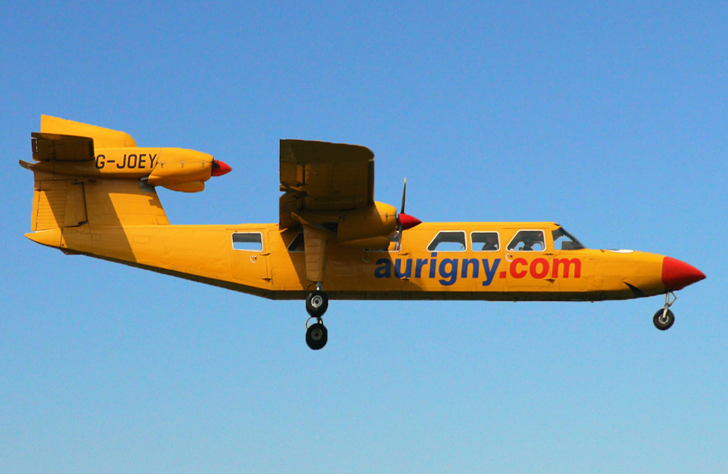 Aurigny Air Services Britten-Norman Trislander G-JOEY in flight with its landing gear extended, the third engine mounted at the top of the tail fin