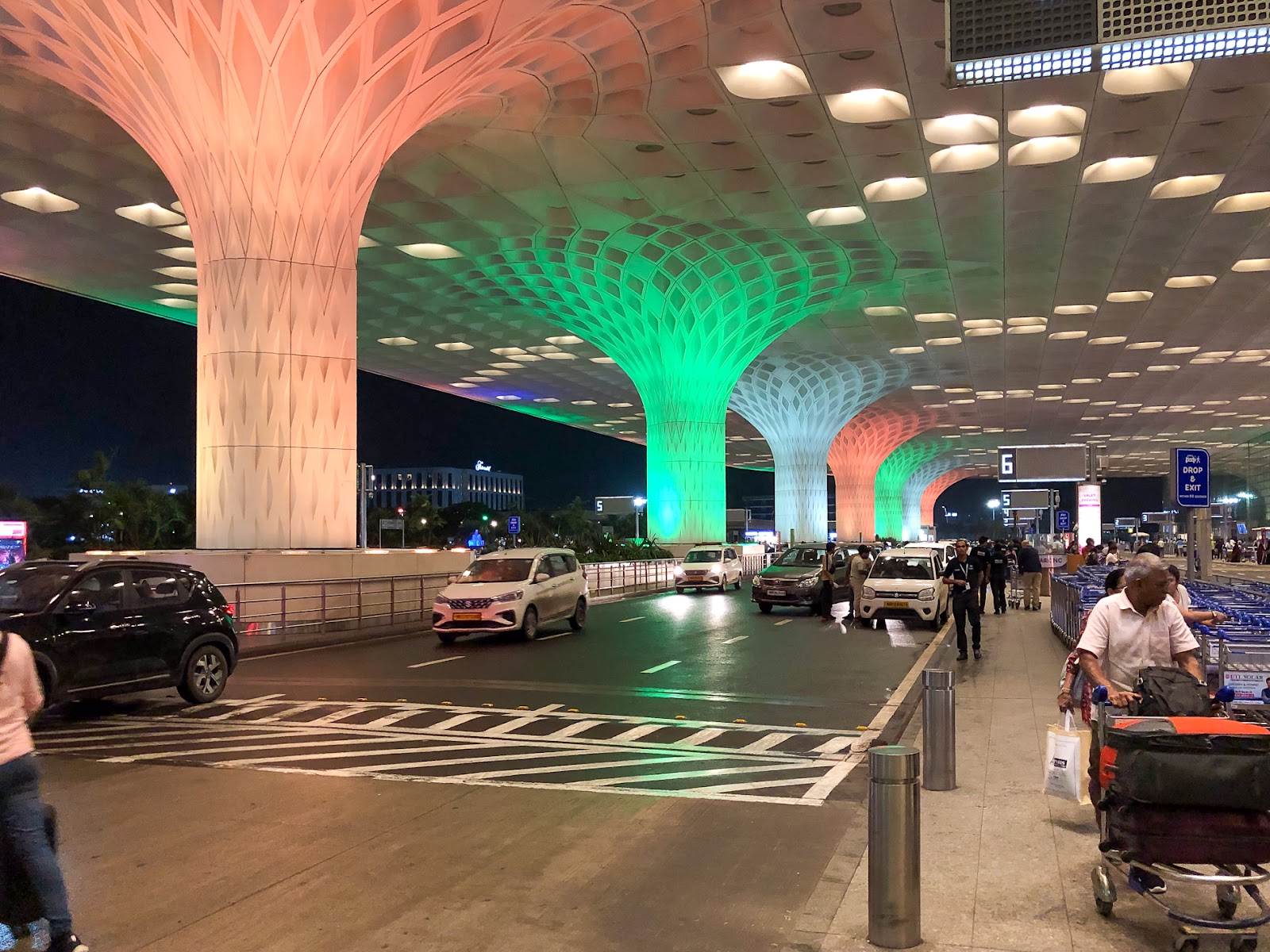 Mumbai Airport Departures at night decorated with Indian colours of saffron, white and green.