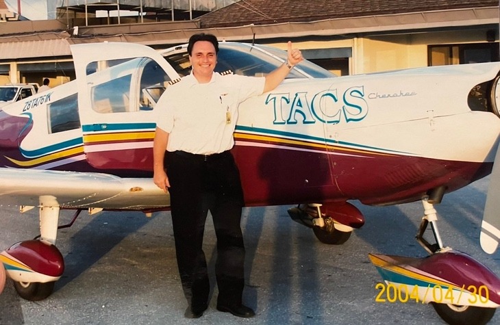 A person standing next to a small planeAI-generated content may be incorrect.