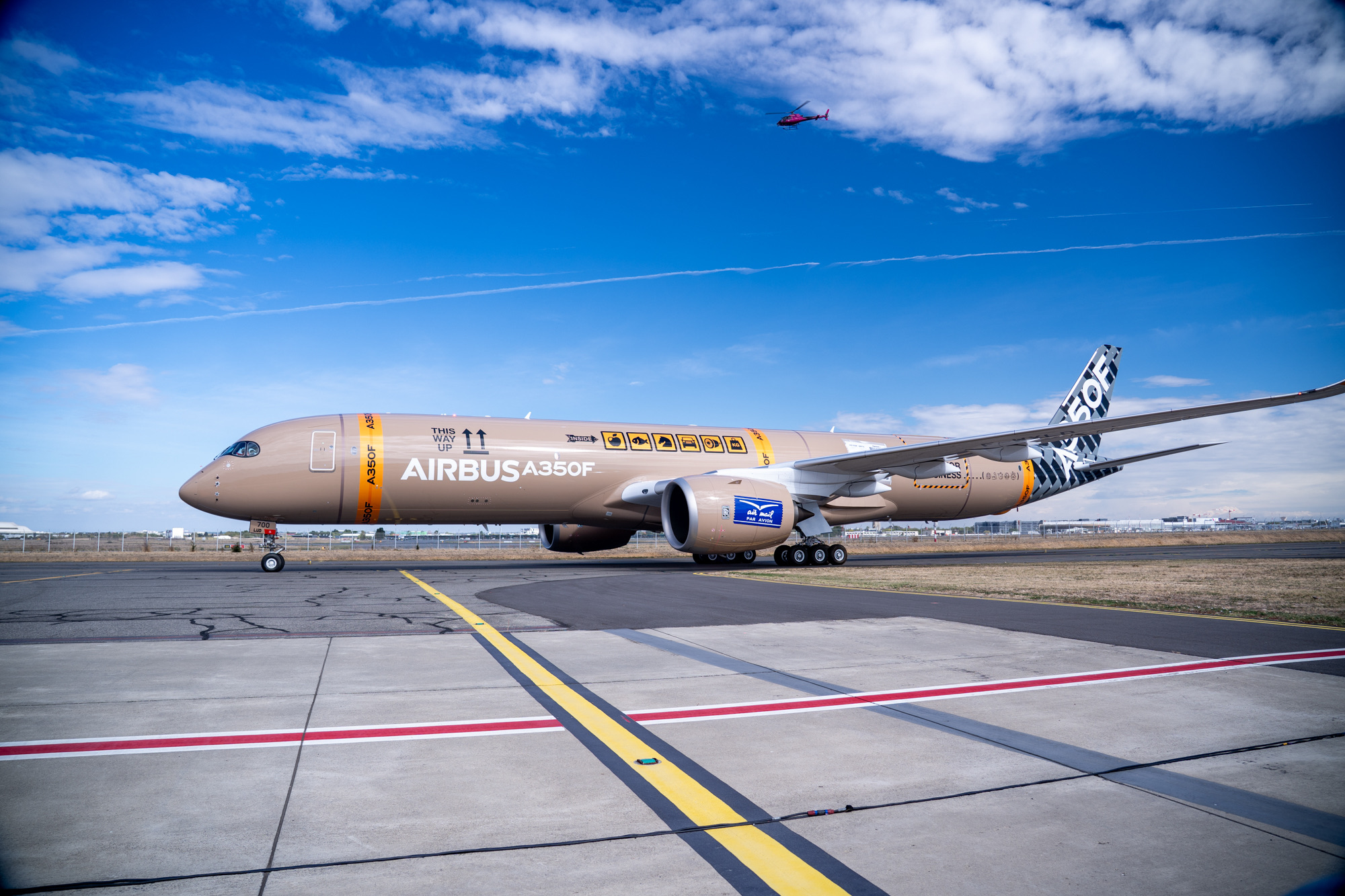 Side view of the A350F in its package-themed livery on the airfield.