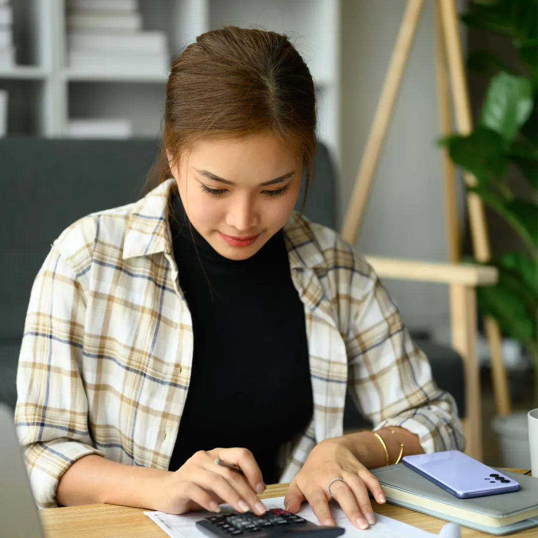 Woman calculating credit utilization ratio