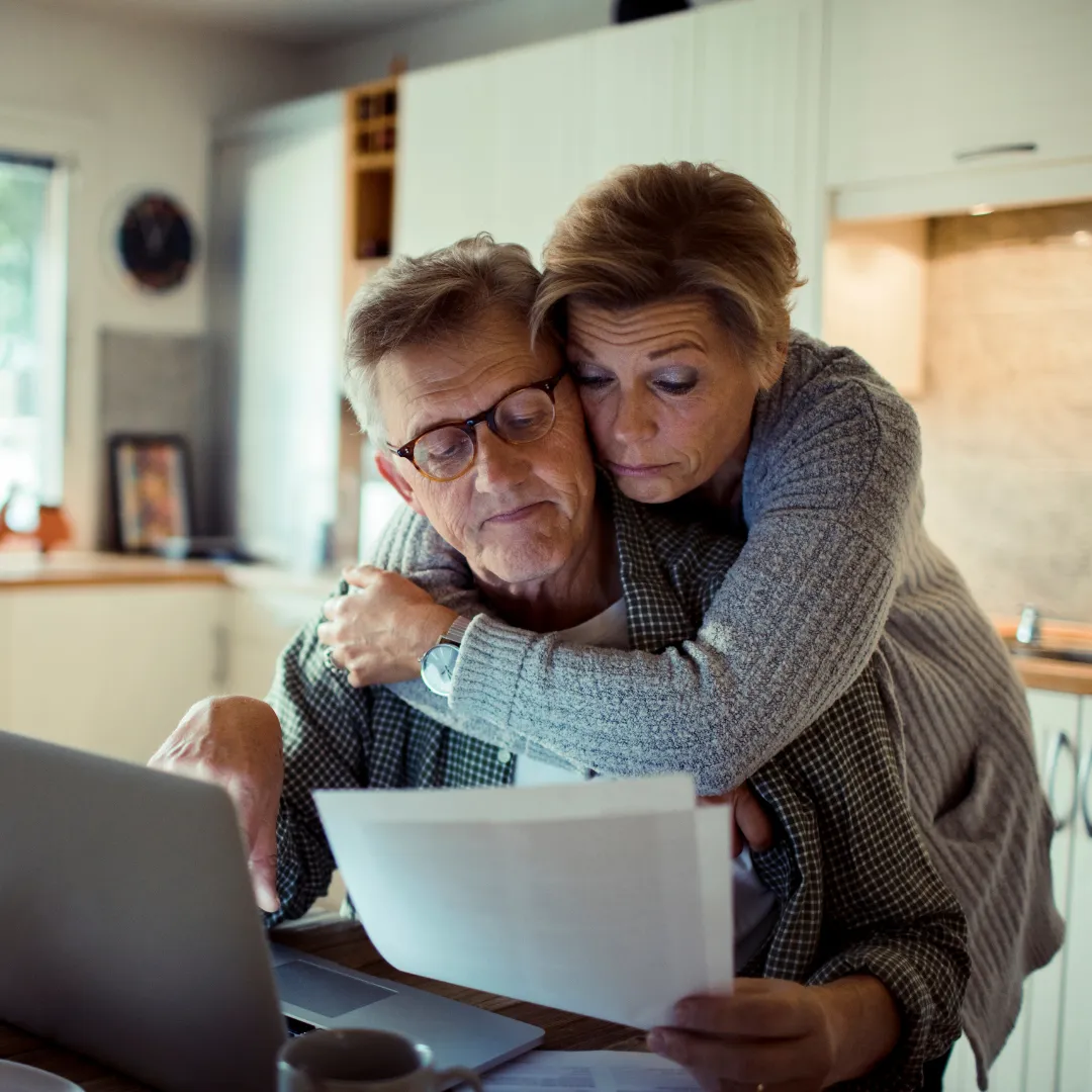 Old couple looking at bills