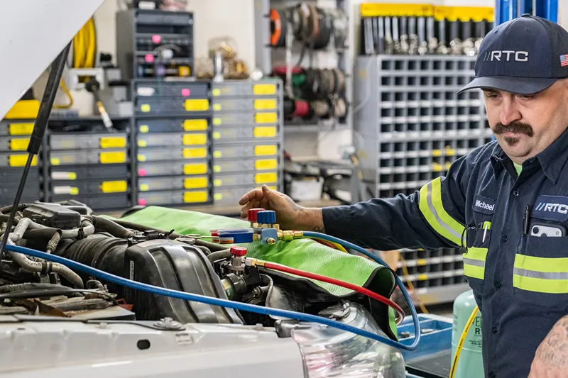 RTC technician performs fluid checks on a commercial fleet vehicle for high-desert summer driving in Redmond.