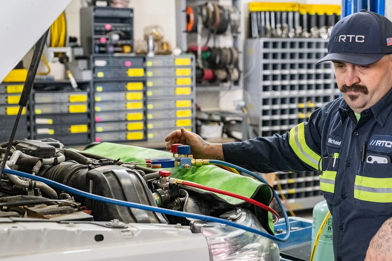 RTC technician performs fluid checks on a commercial fleet vehicle for high-desert summer driving in Redmond.
