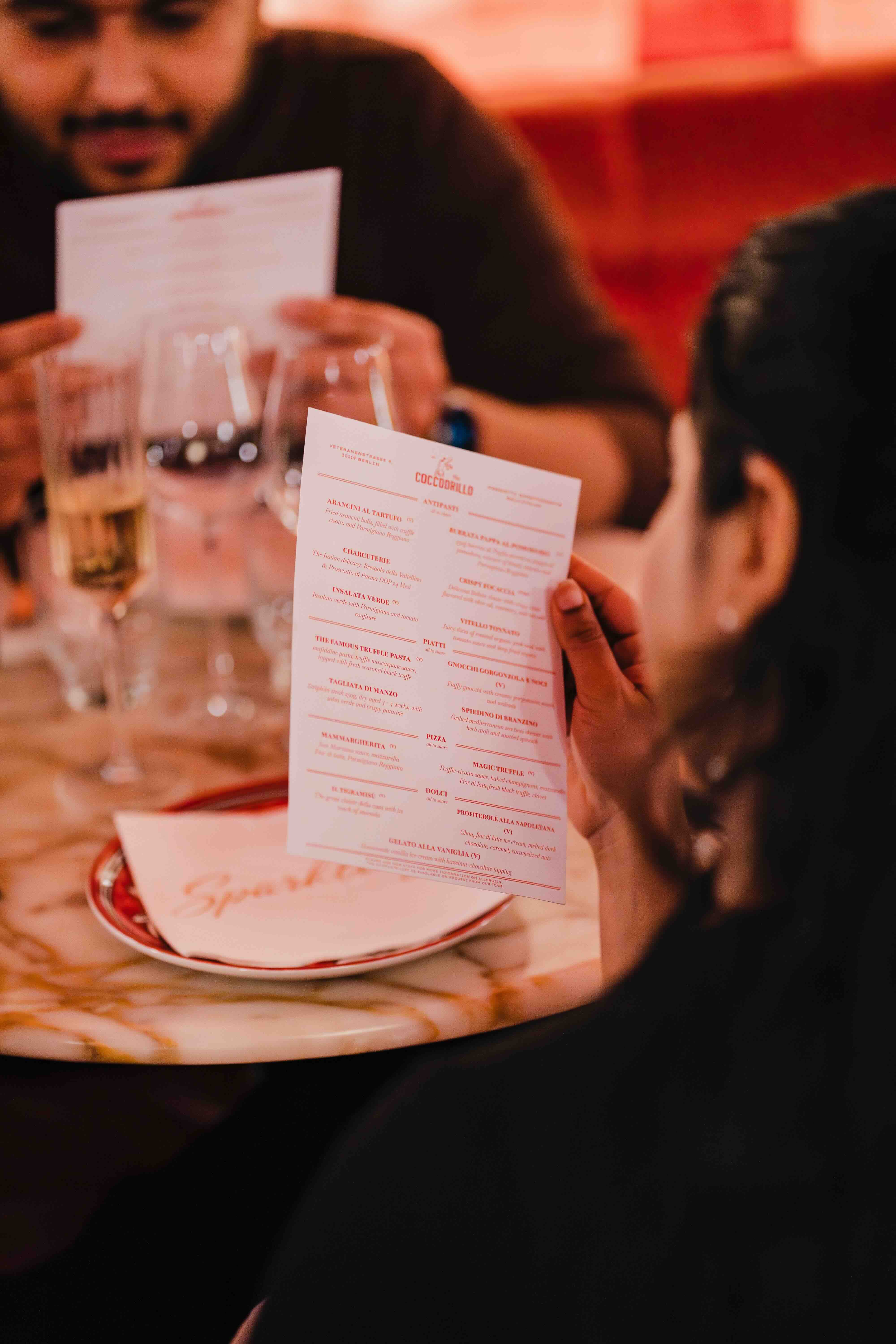 People in a restaurant looking at a menu.